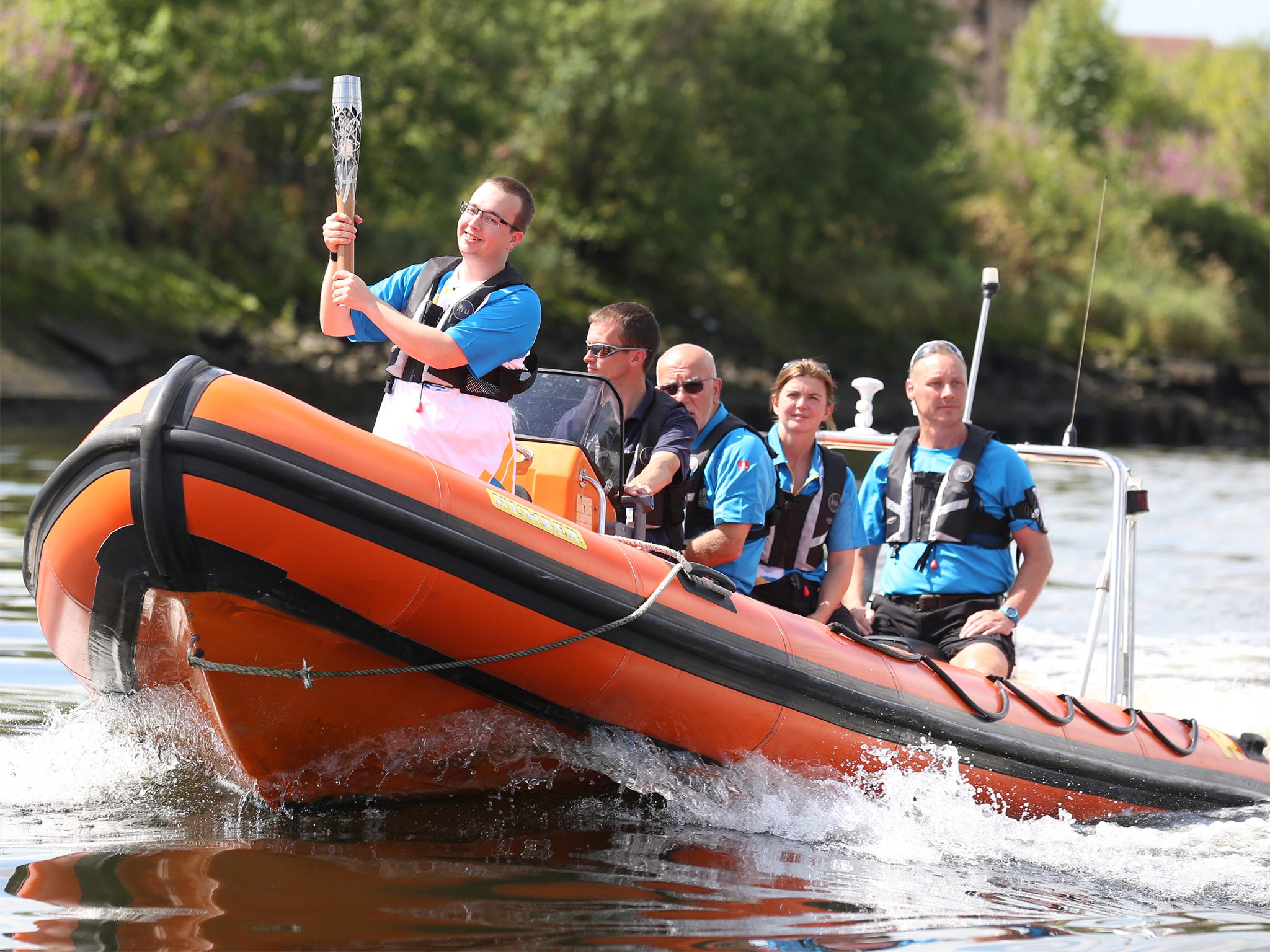 The Queen's Baton is carried by boat on the River Clyde on its way to the Games