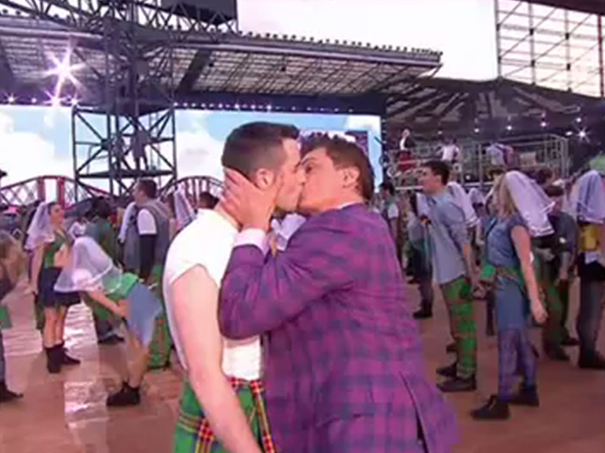 John Barrowman kisses his male “bride” at a mock Gretna Green during the Commonwealth Games opening ceremony