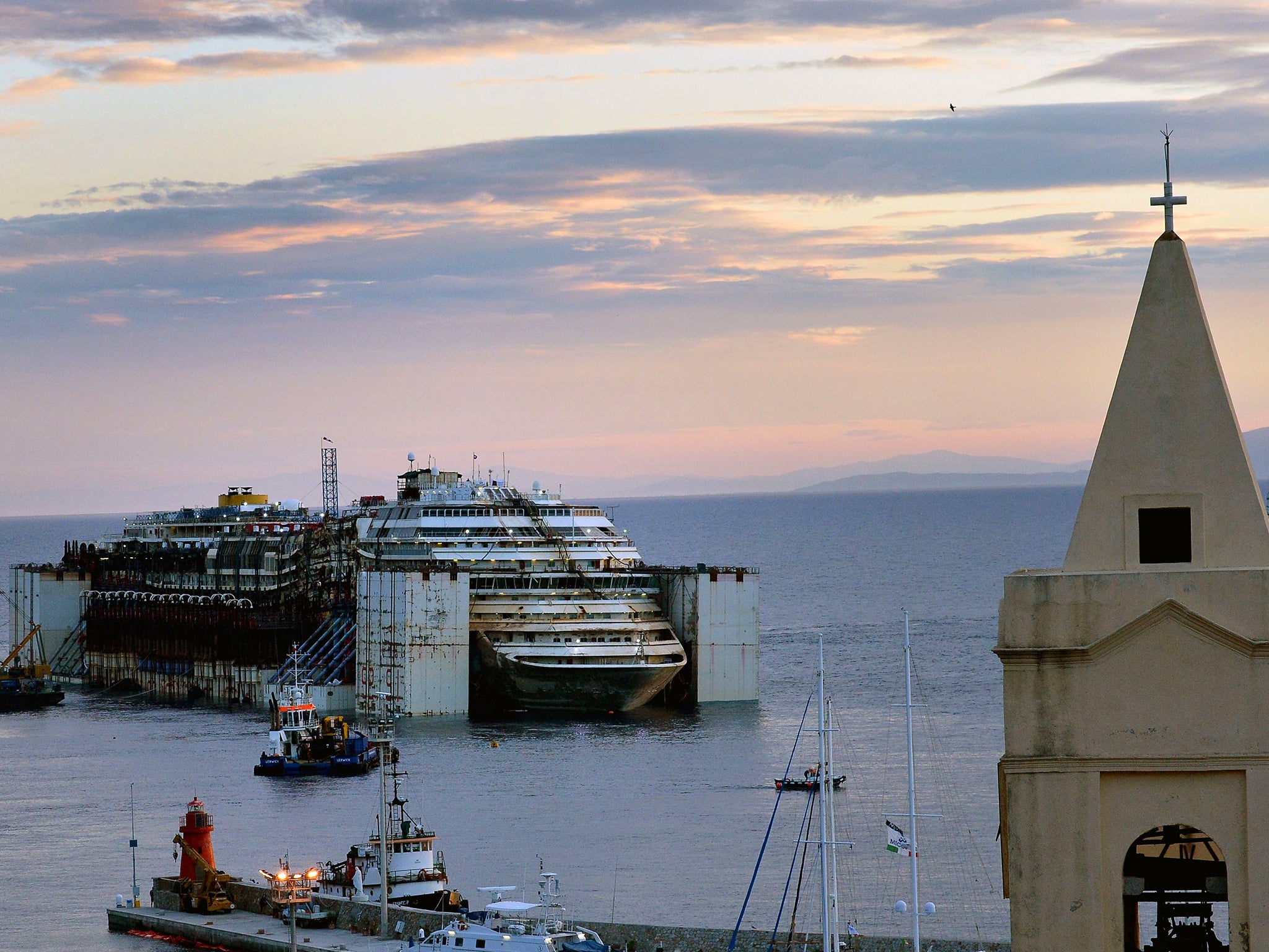 Costa Concordia cruise ship after being refloated using air tanks attached to its sides at Giglio Island