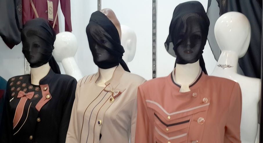 In this Monday, July 21, 2014 photo, mannequins with their faces covered are displayed in a shop window in central Mosul, 225 miles (360 kilometers) northwest of Baghdad, Iraq. The Islamic State group ordered clothes shop owners to cover the faces of the