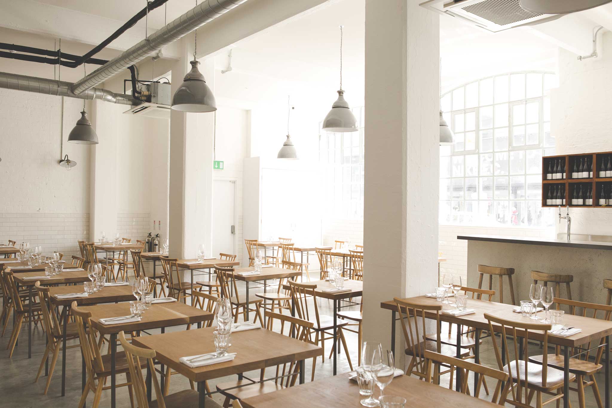 Lyle's décor is spartan: school-lavatory white tiles, concrete floor, junior tables and chairs