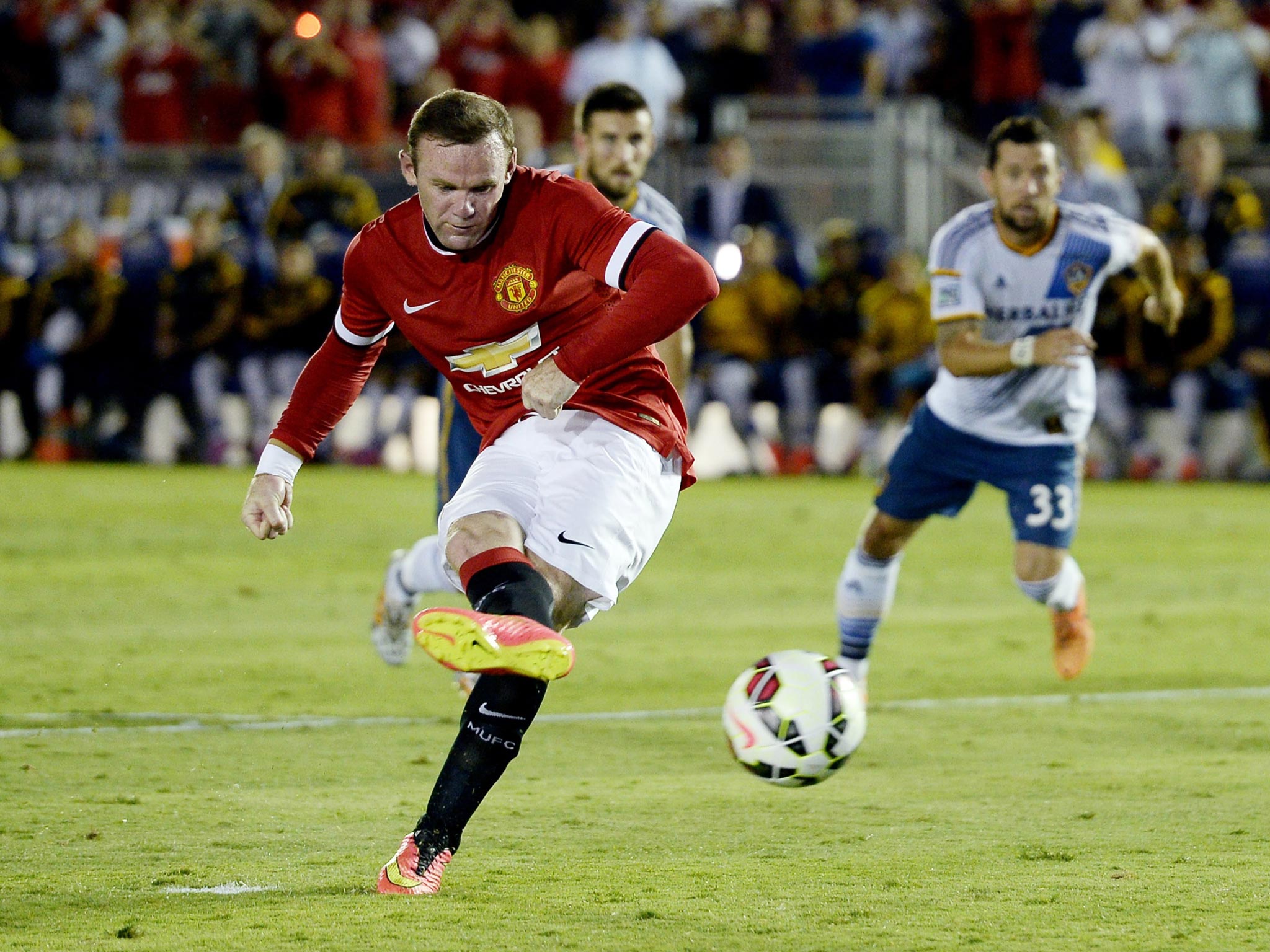 Wayne Rooney scores from the penalty spot against LA Galaxy