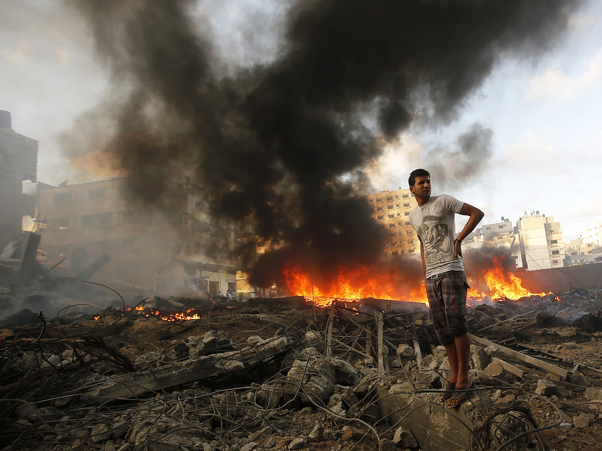 Palestinians inspect the rubble of a destroyed house after Israeli airstrikes in Al Tufah neighbourhood in eastern Gaza City