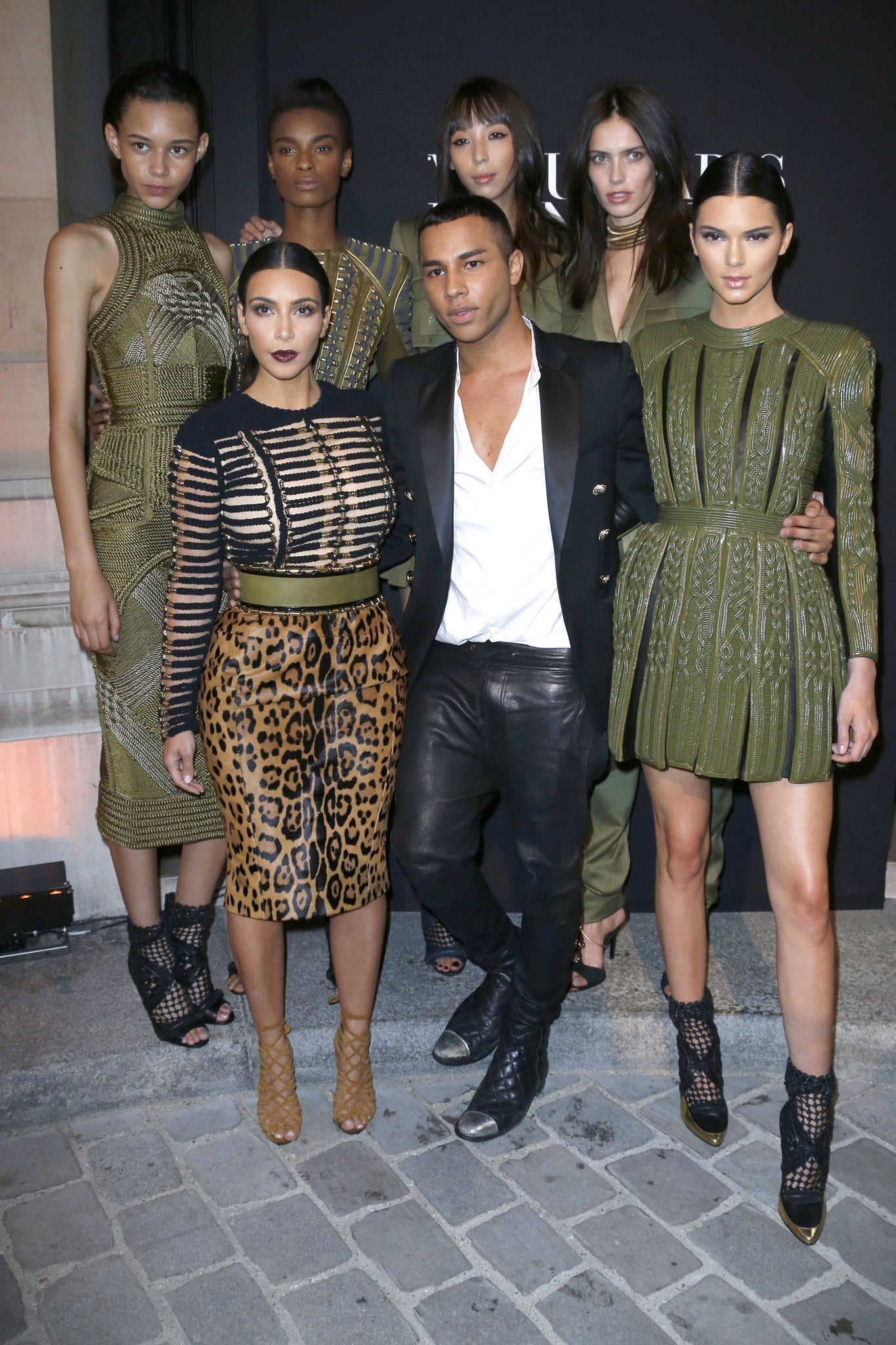 Olivier Rousteing with Kim Kardashian, flanked by models wearing autumn/winter 2014 Balmain