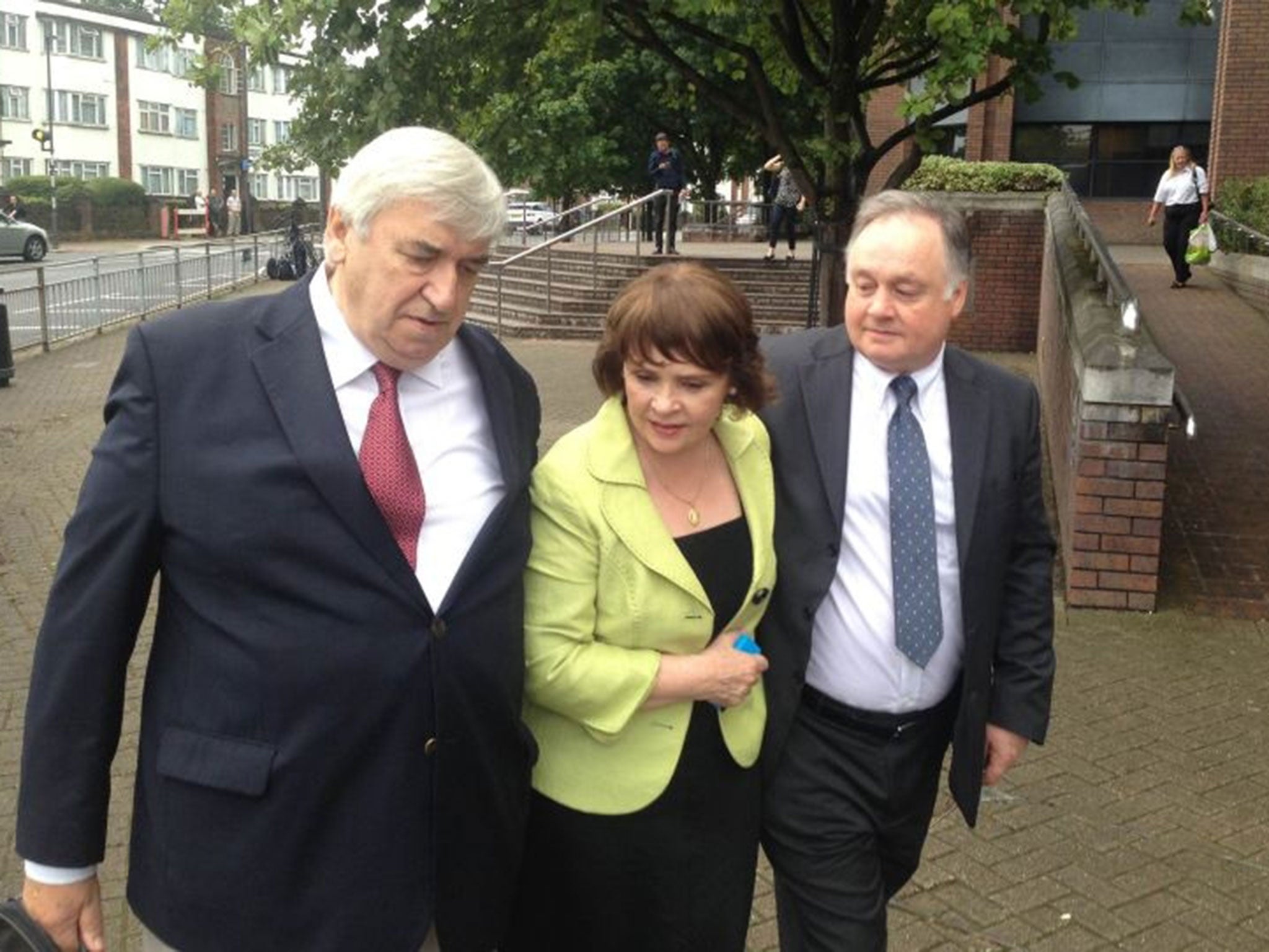 John Brown (right) with his sister, Eurovision Song Contest winner and former Irish presidential candidate Dana Rosemary Scallon, and her husband Damien Scallon, as he leaves Harrow Crown Court after he was found not guilty of five counts of historic sex