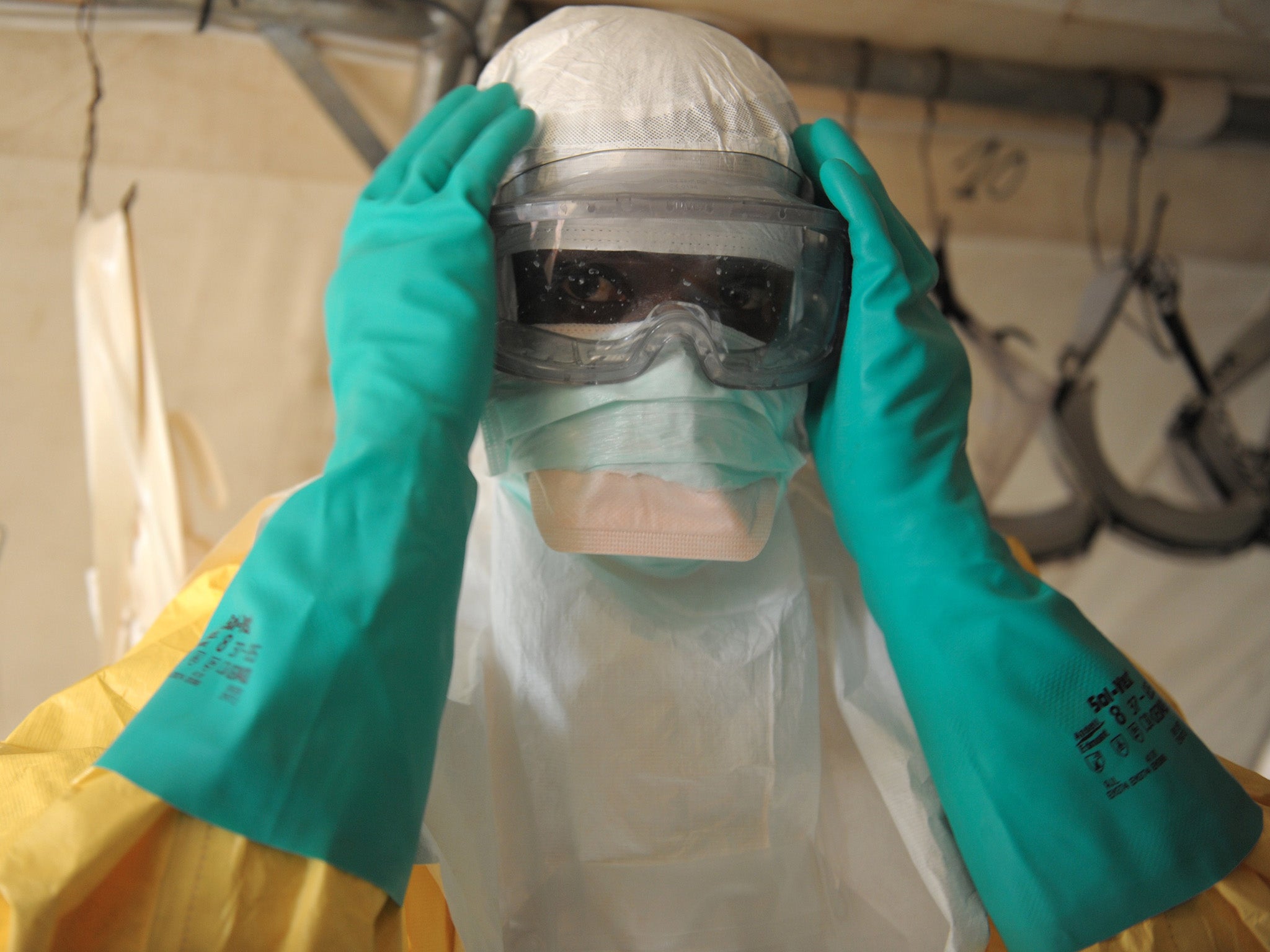 A health specialist prepares for work in an isolation ward for patients at the Doctors Without Borders facility in southern Guinea.