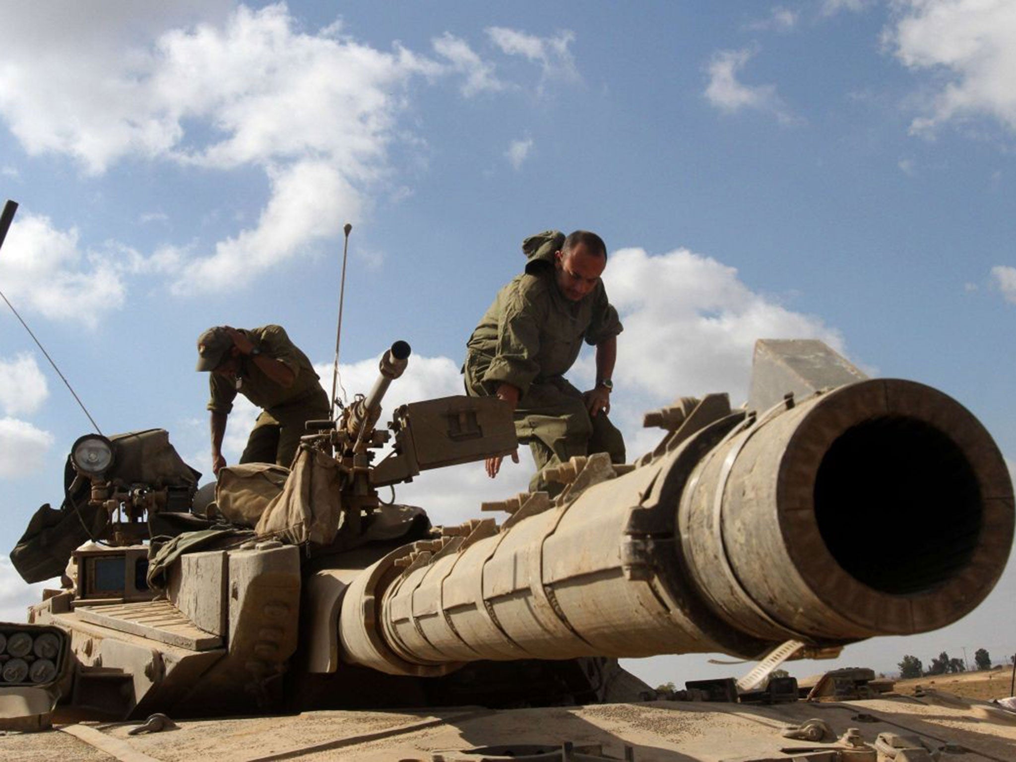 Firepower: An Israeli tank takes aim on the Gaza border yesterday