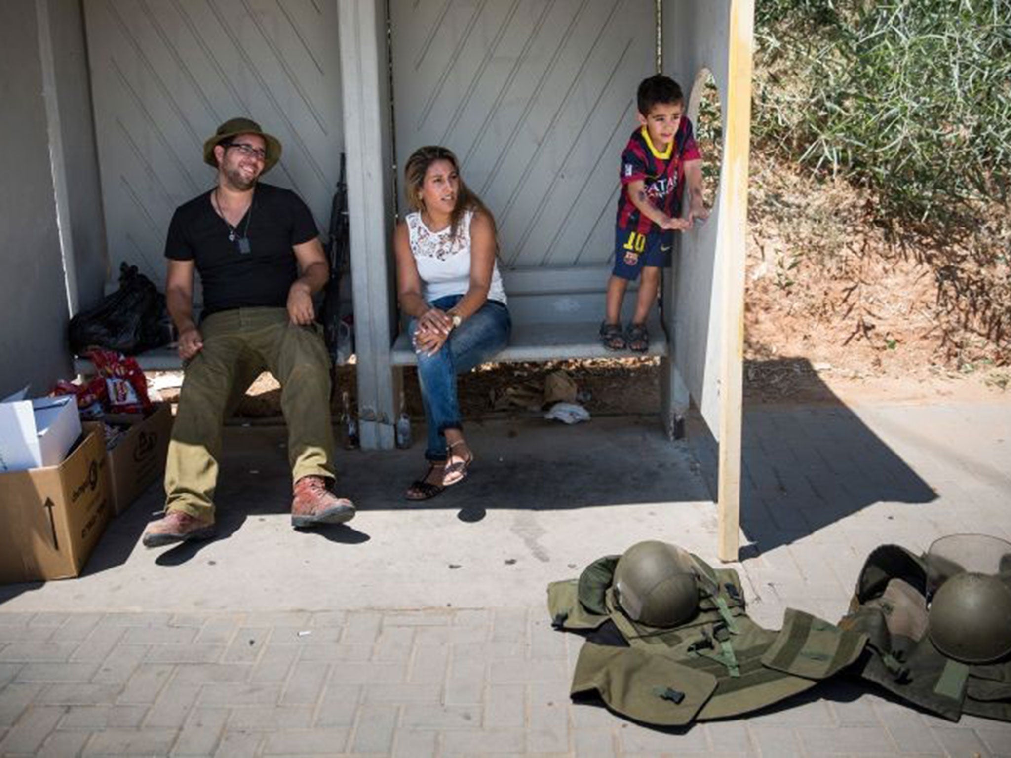 Life goes on: An Israeli soldier meets his family during the 12-hour ceasefire yesterday