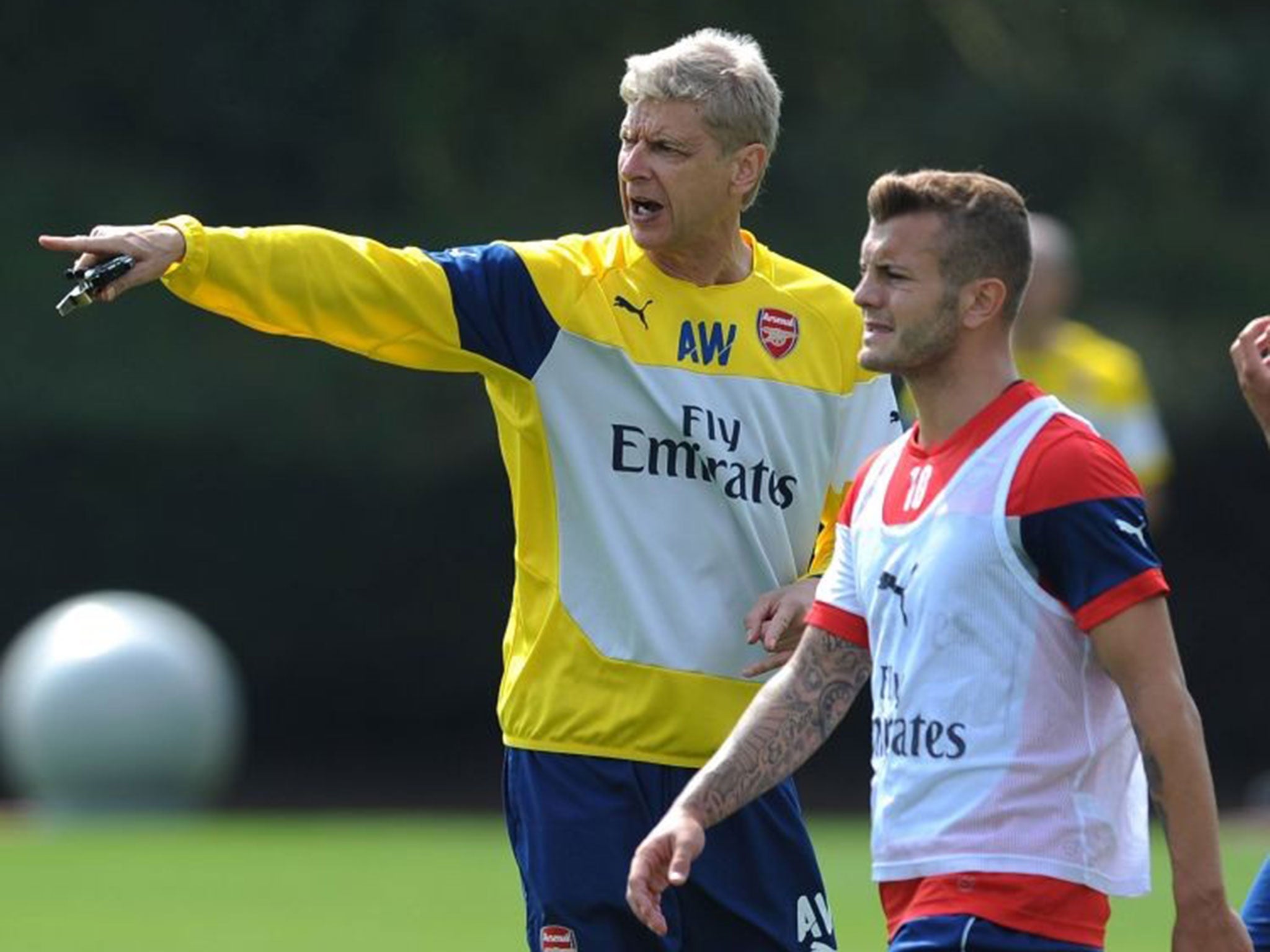 Follow my leader: Jack Wilshere listens to manager Arsène Wenger