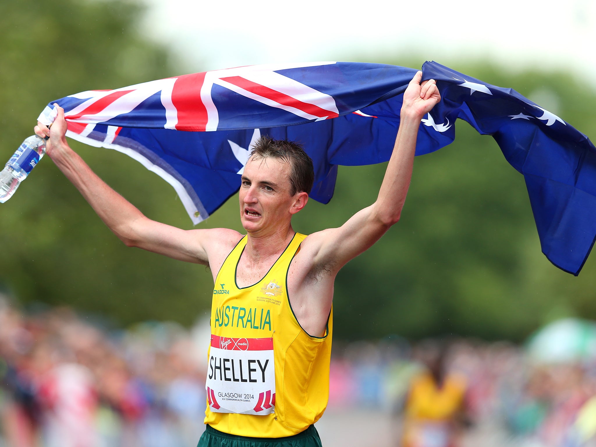 Michael Shelley of Australia celebrates as he crosses the line to win the Men's Marathon