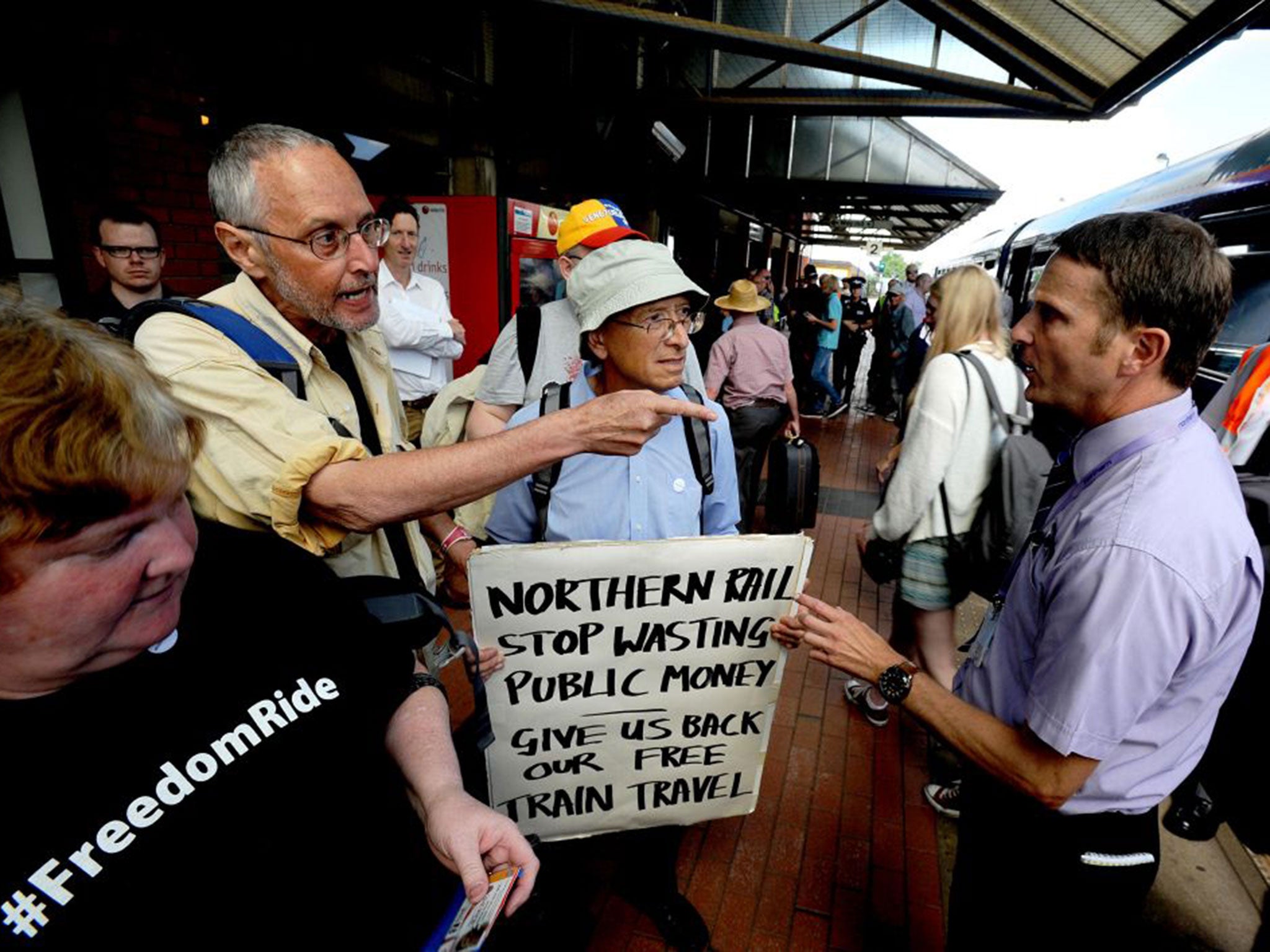 Freedom Ride campaigners remonstrate with a railway official on the platform at Barnsley station after a group of them forced open gates in order to travel Meadowhall