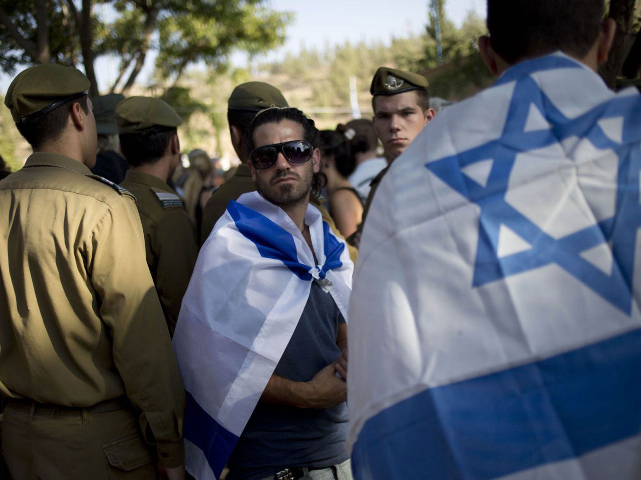 Israeli soldiers at the funeral yesterday of Captain Liad Lavi, who died from his wounds after being injured fighting in Gaza