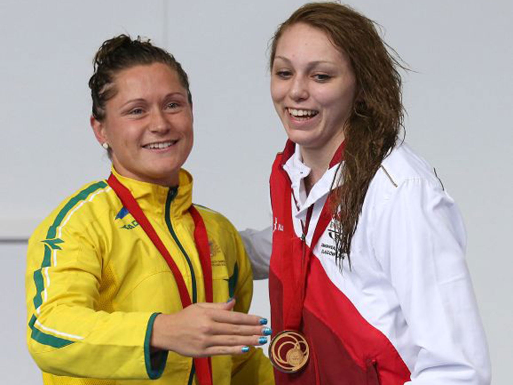 Sophie Taylor, right, embraces Australia’s Lorna Tonks on the podium