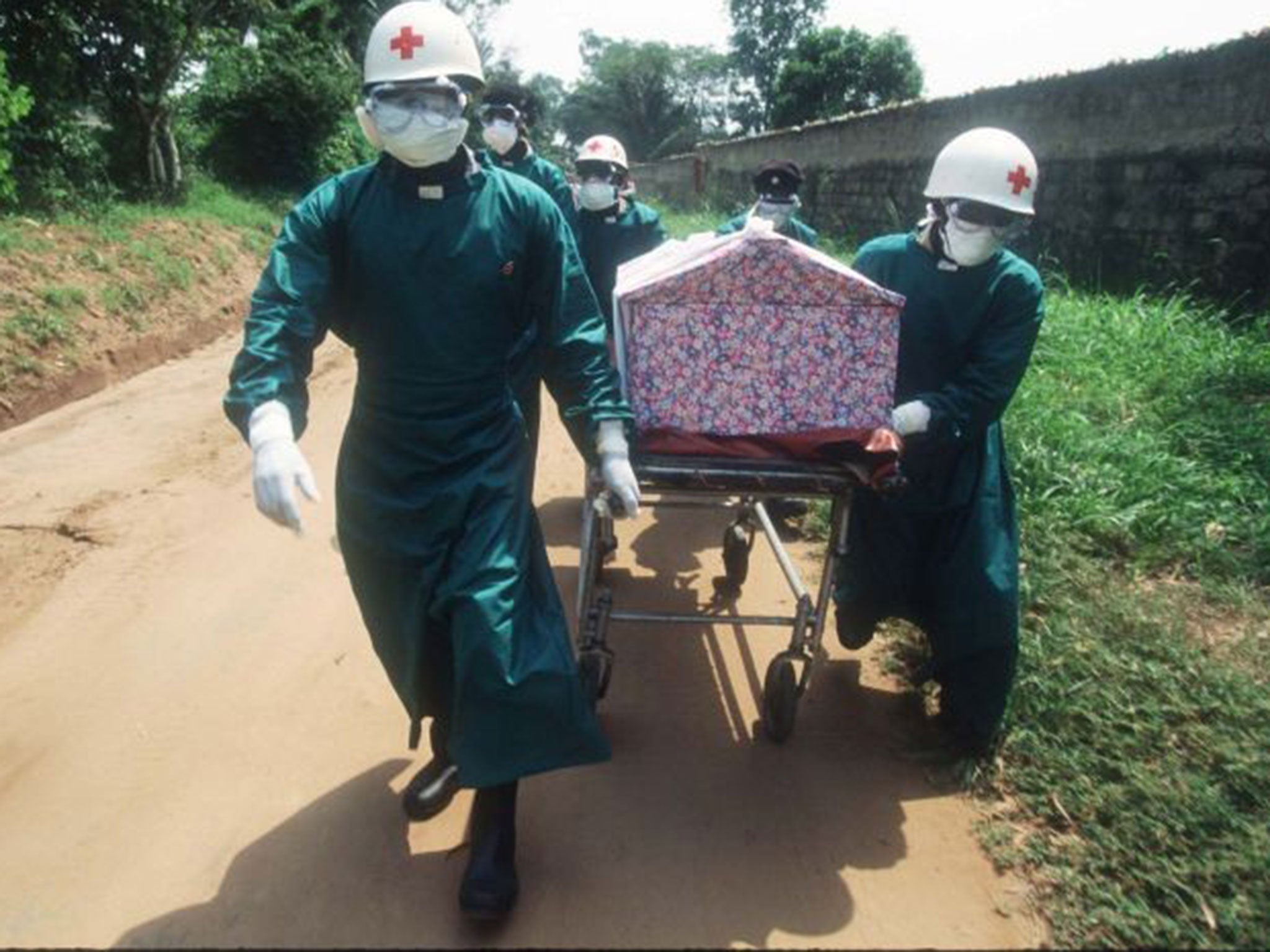 Body of evidence: health workers transport a casket of a nun whose death resulted from an Ebola infection in Zaire in 1995