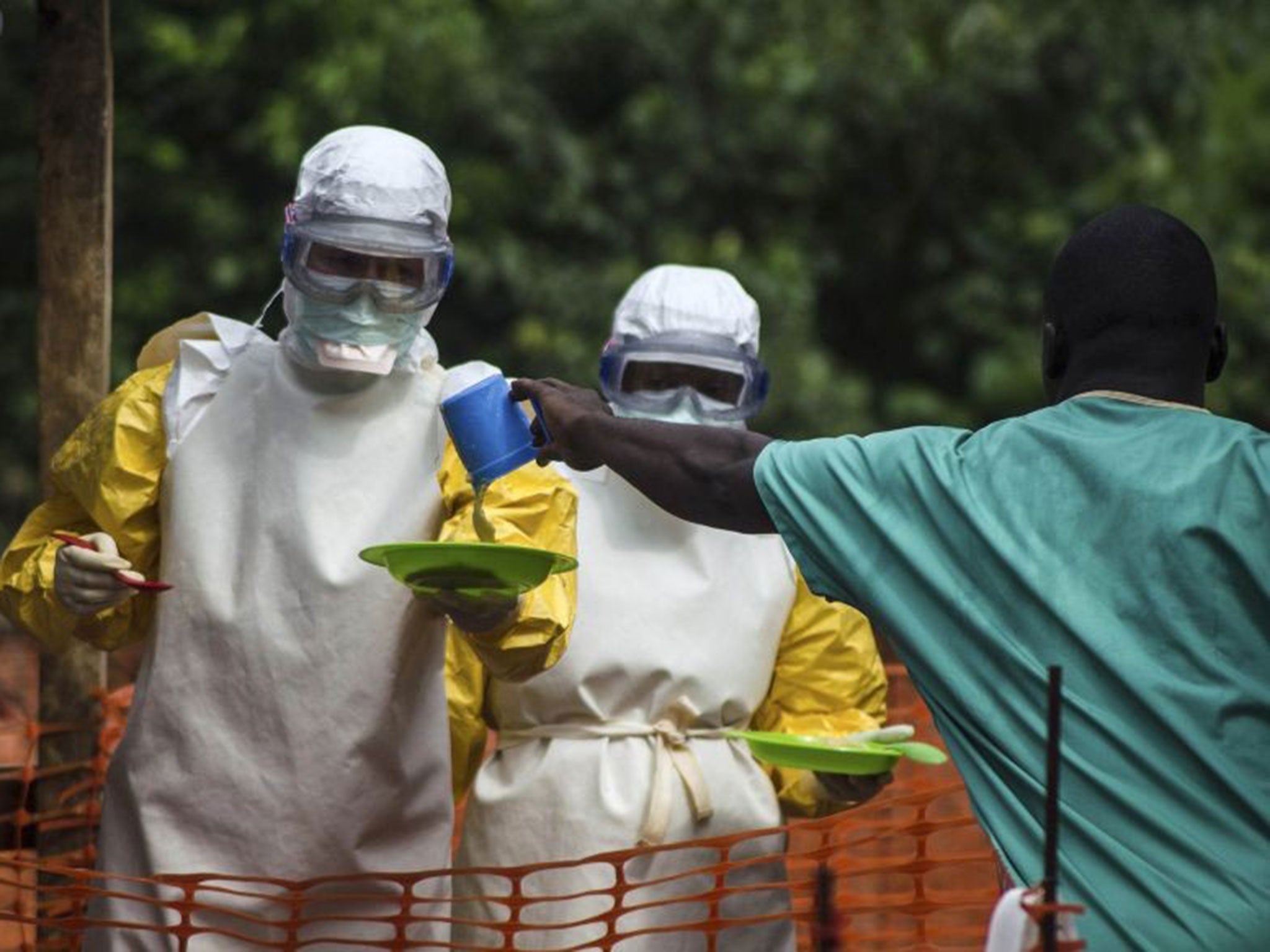 Medical staff working with Medecins sans Frontieres prepare to bring food to patients kept in an isolation area (Reuters)