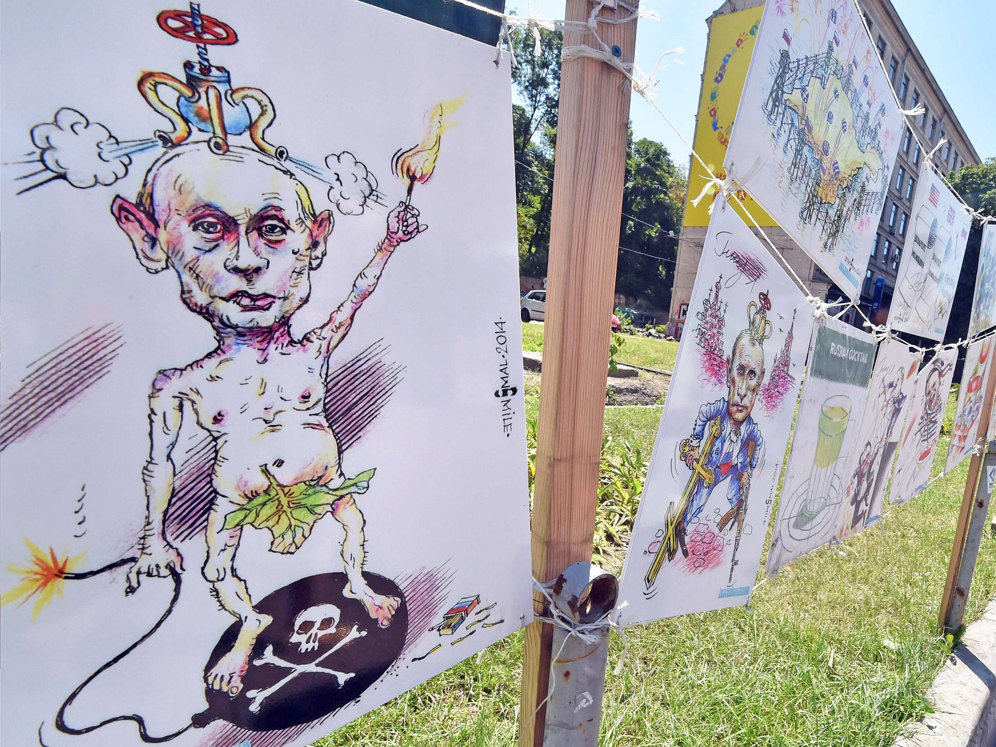 Caricatures of Russian President Vladimir Putin at an open-air exhibition by Ukrainian cartoonist Oleh Smal, in the center of Kiev (Getty)