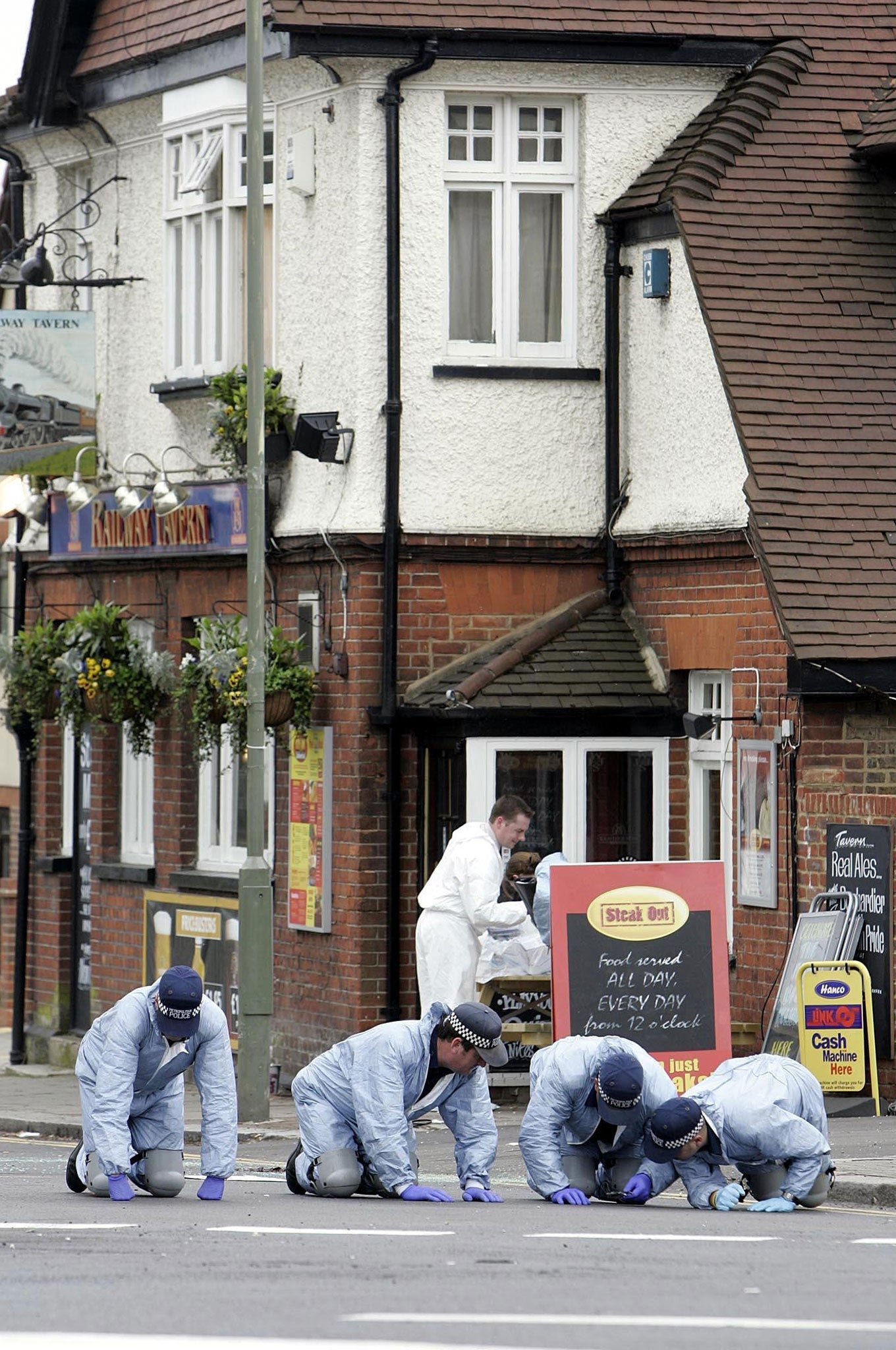 April 2005: A police forensics team searching outside The Railway Tavern on Hale Lane at the scene where Azelle Rodney died