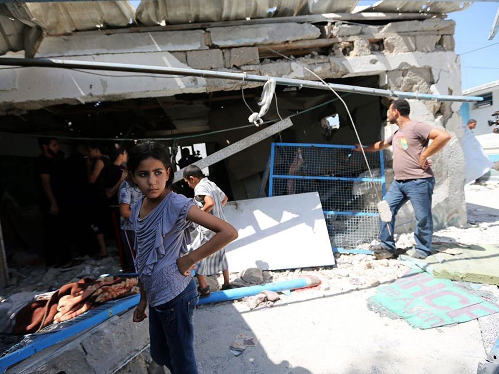 Palestinians inspect a destroyed classroom of a UN school in Jabalia, northern Gaza Strip