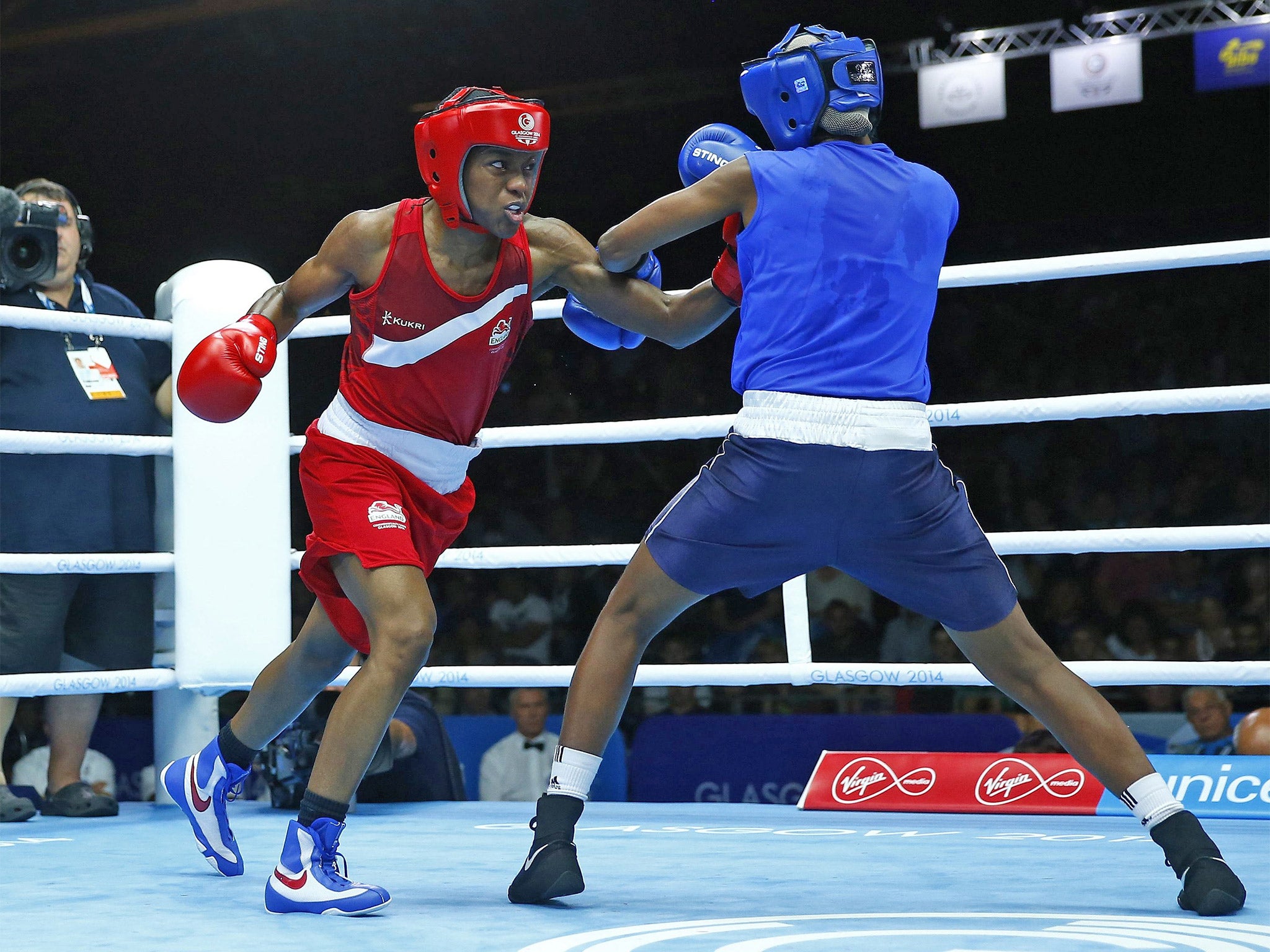 England’s Nicola Adams (left) dominates Erandi de Silva, of Sri Lanka, to guarantee herself a bronze medal at the very least