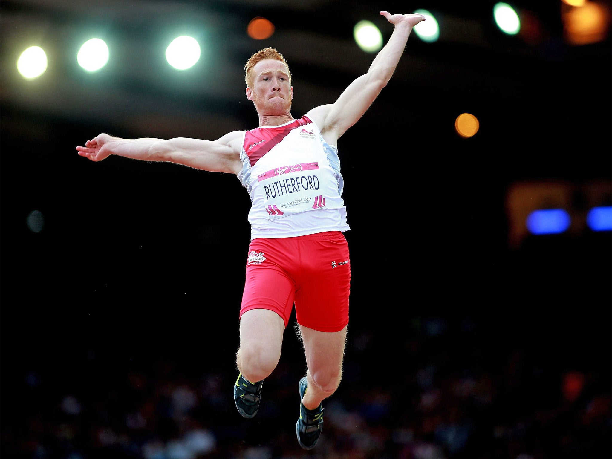 England’s Greg Rutherford leaps into the air as he captures the gold medal in the long jump competition inside Hampden Park