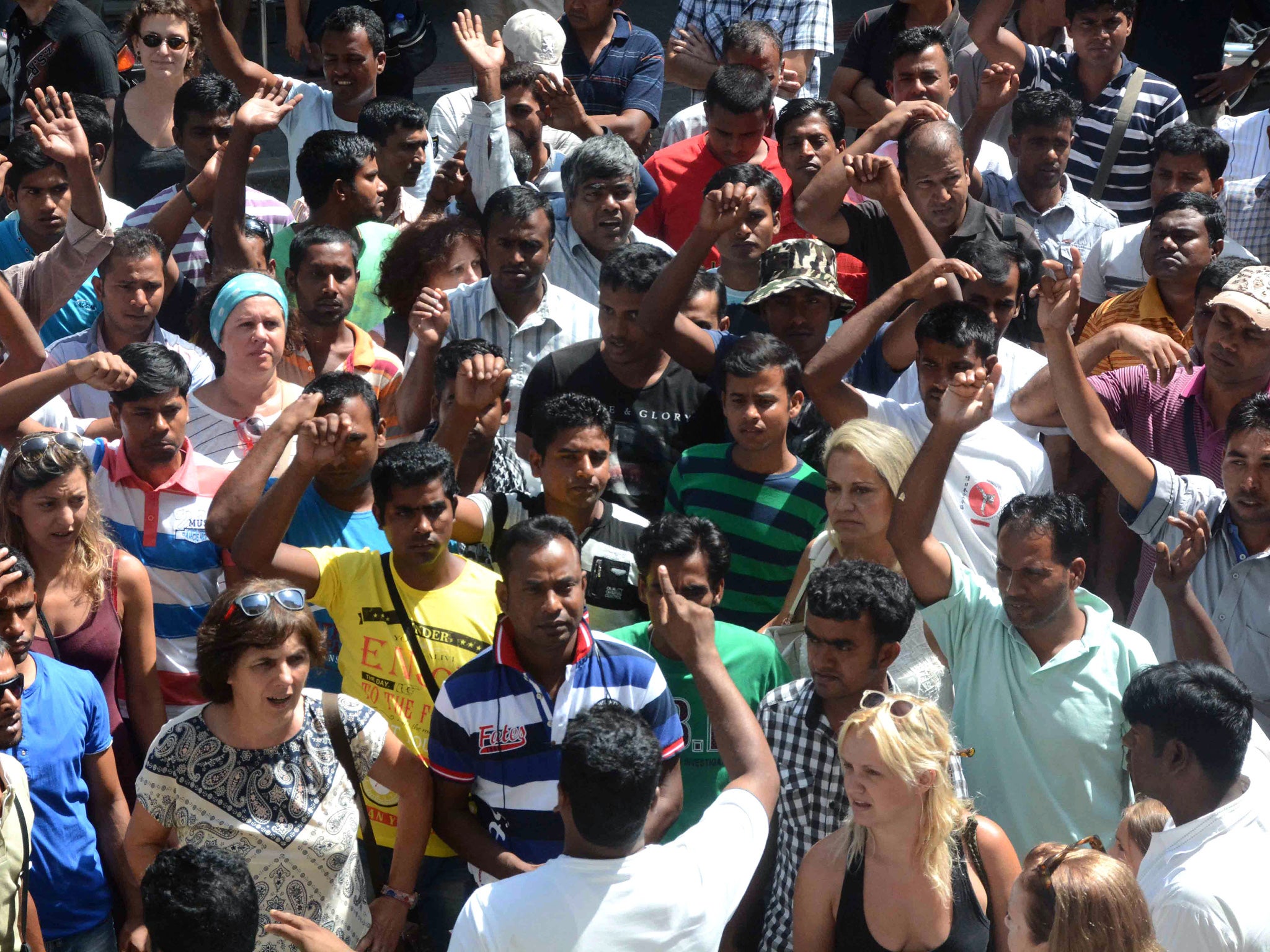 Protesters outside a court in the city of Patras, Greece after it convicted two employees at a strawberry farm for shooting and wounding workers protesting unpaid wages - but the farm's owner and head foreman were cleared