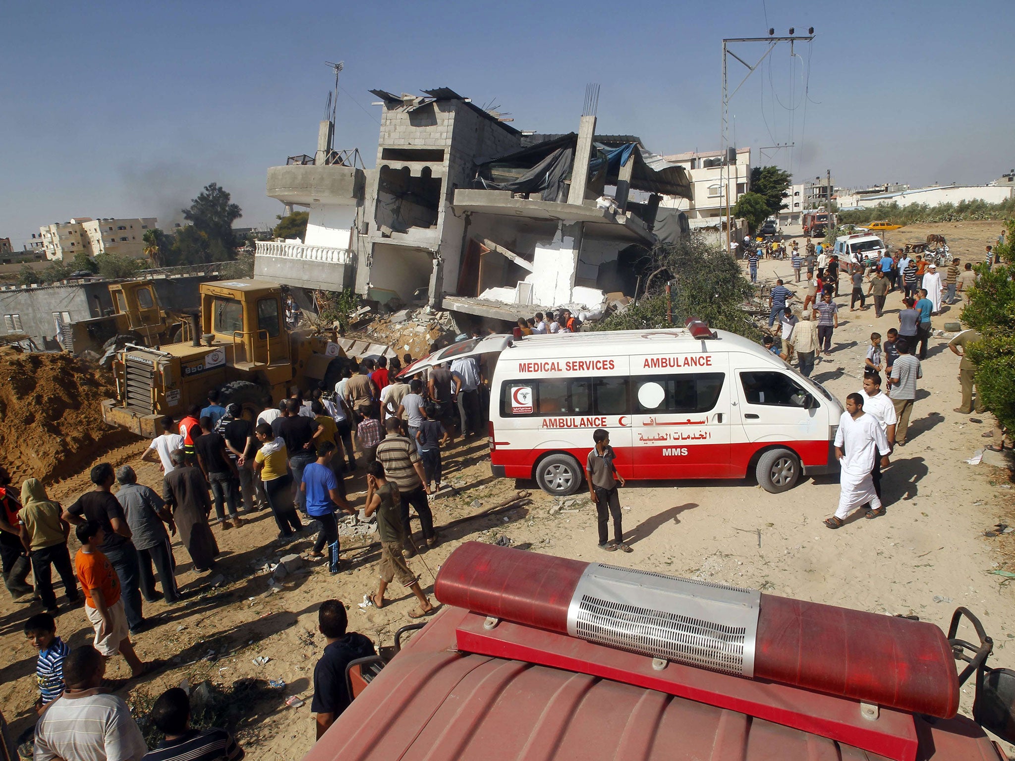 Palestinian rescue workers search the rubble for survivors following a strike on Rafah, in the southern Gaza Strip