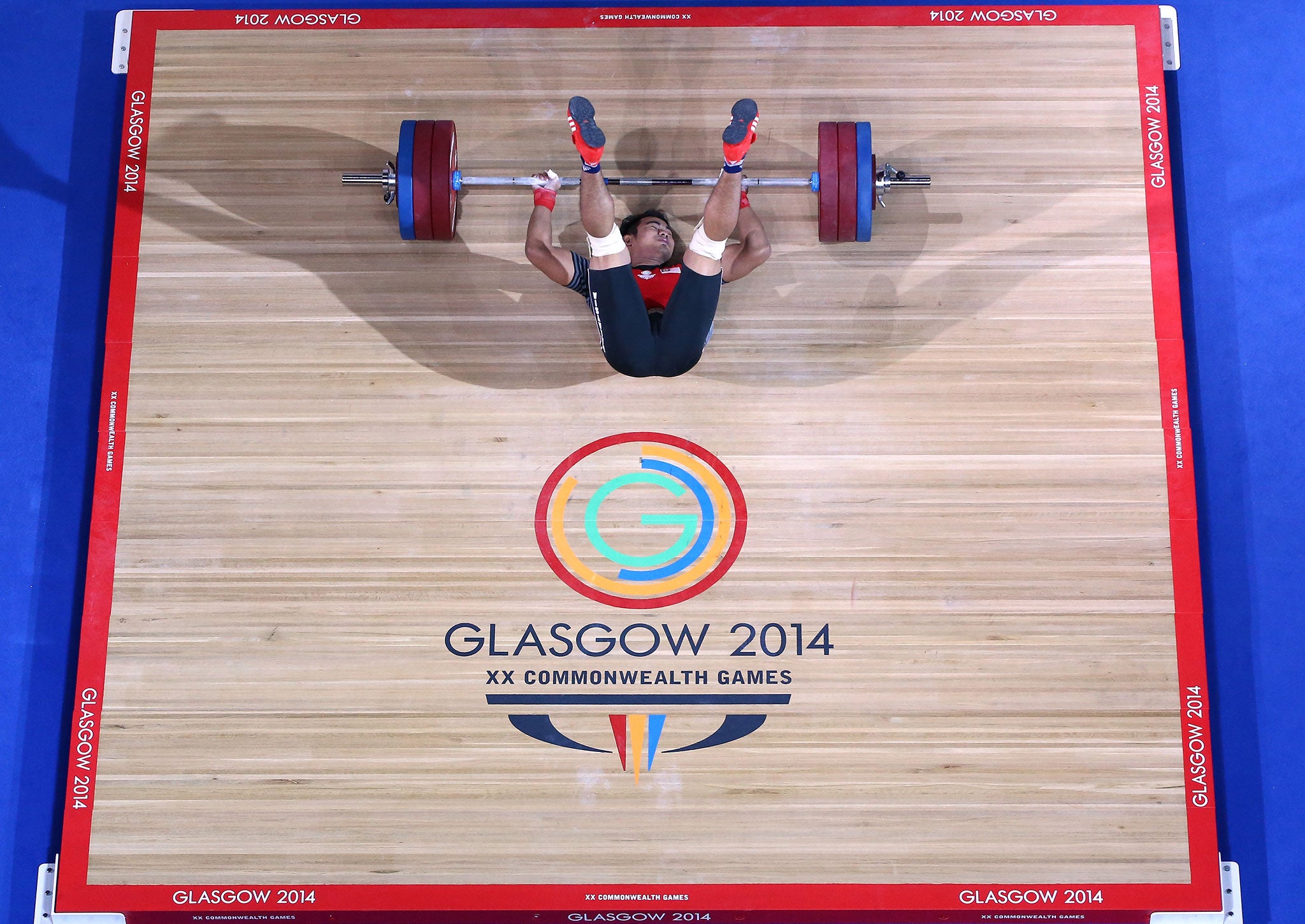 Abd Mubin Rahim of Malaysia falls to the floor after an unsuccessful lift during the Men's Weightlifting