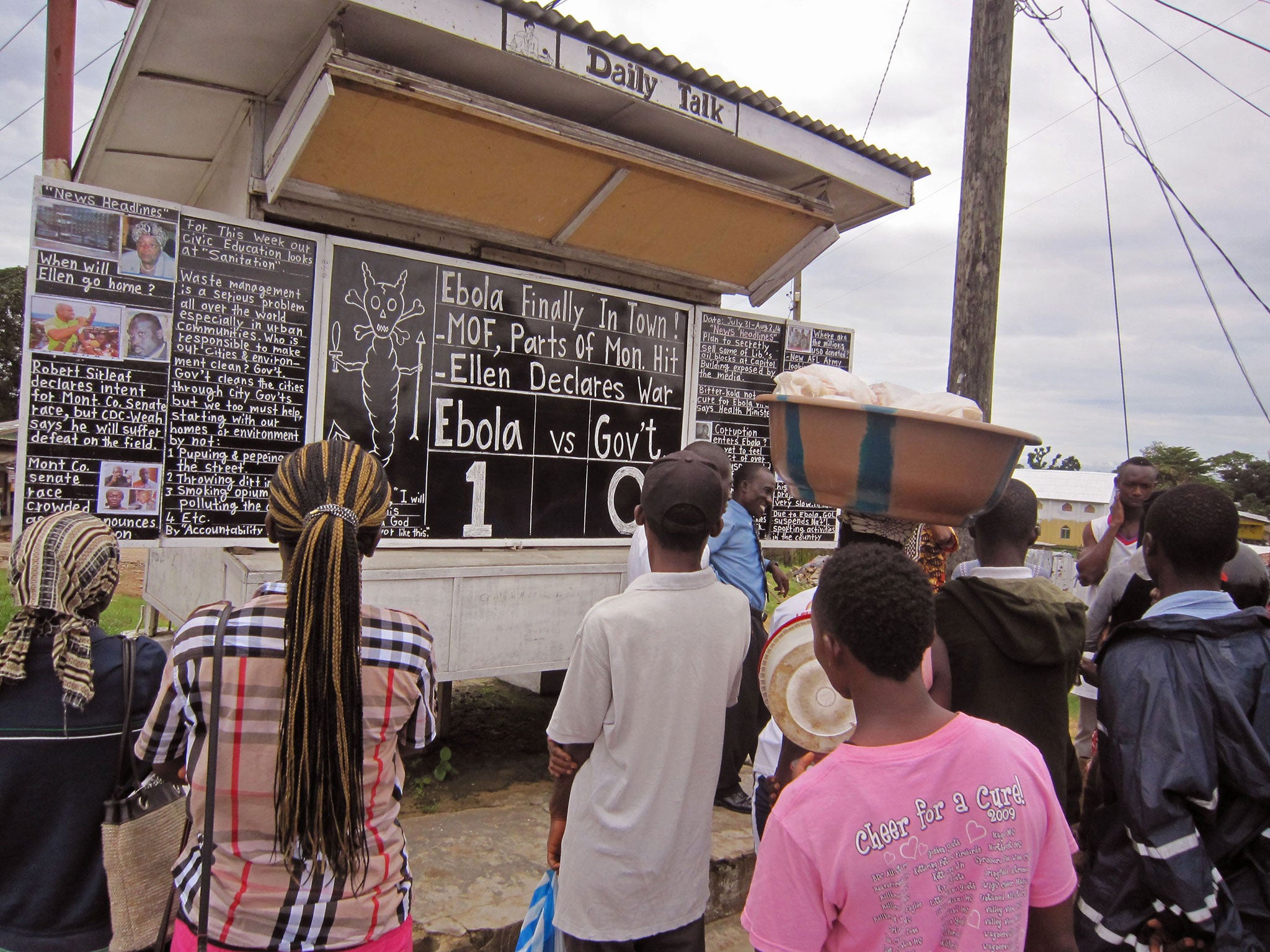 Social Commentator Alfred Sirleaf (centre rear) gives comment on current events in Liberia