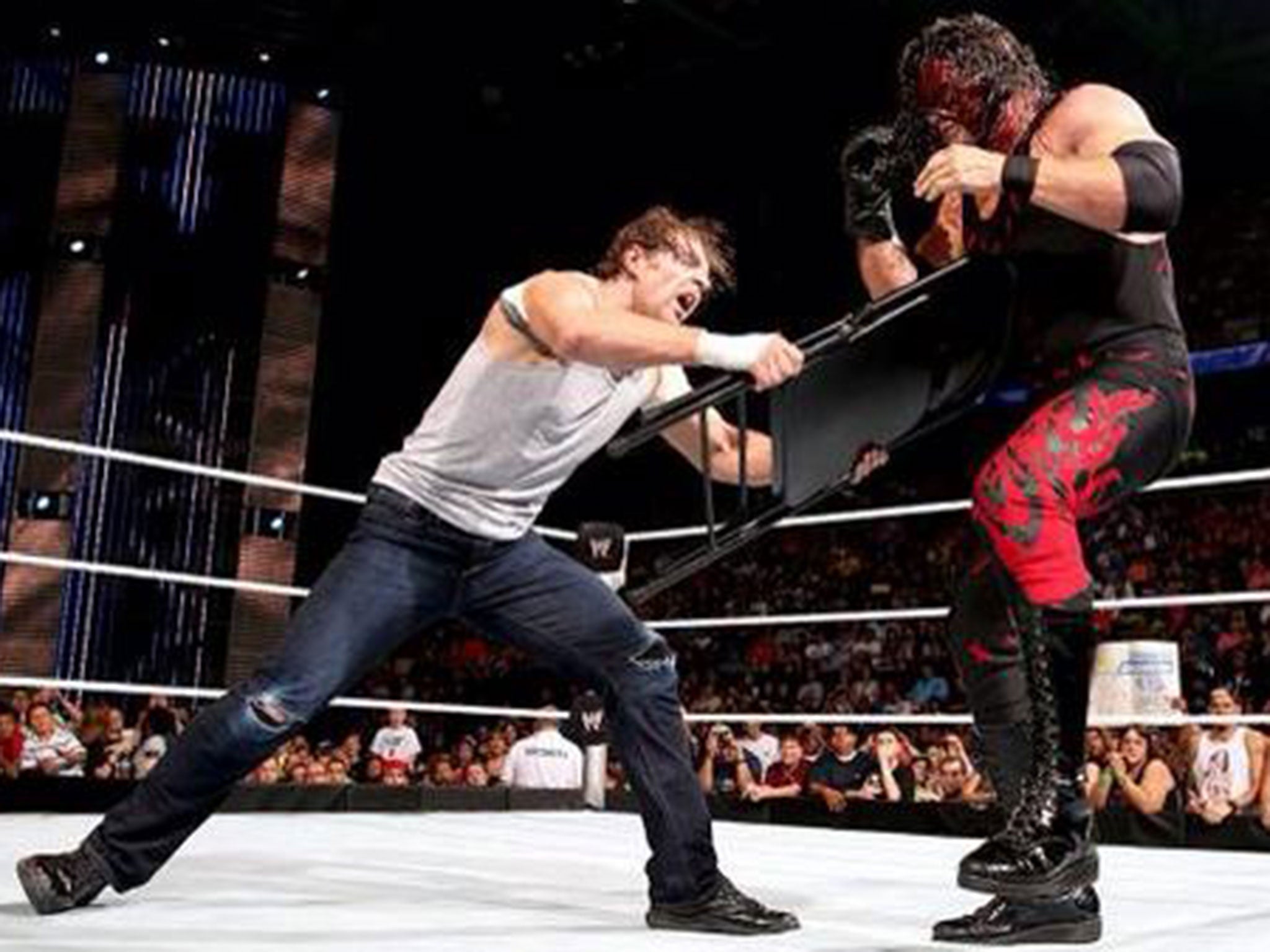 Dean Ambrose levels the playing field with a chair in his handicap match against Kane and Seth Rollins