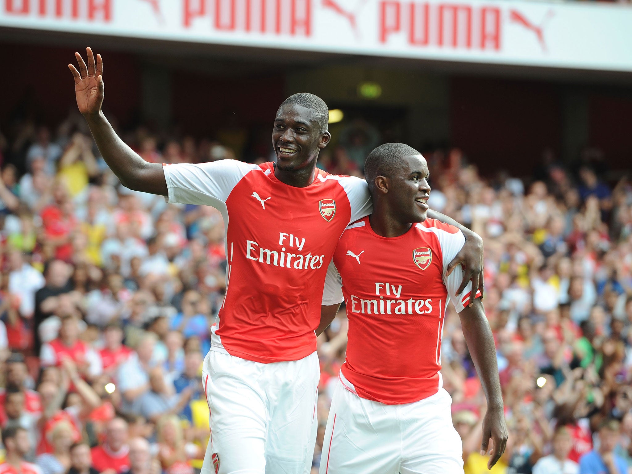 Yaya Sanogo celebrates scoring against Benfica with Joel Campbell