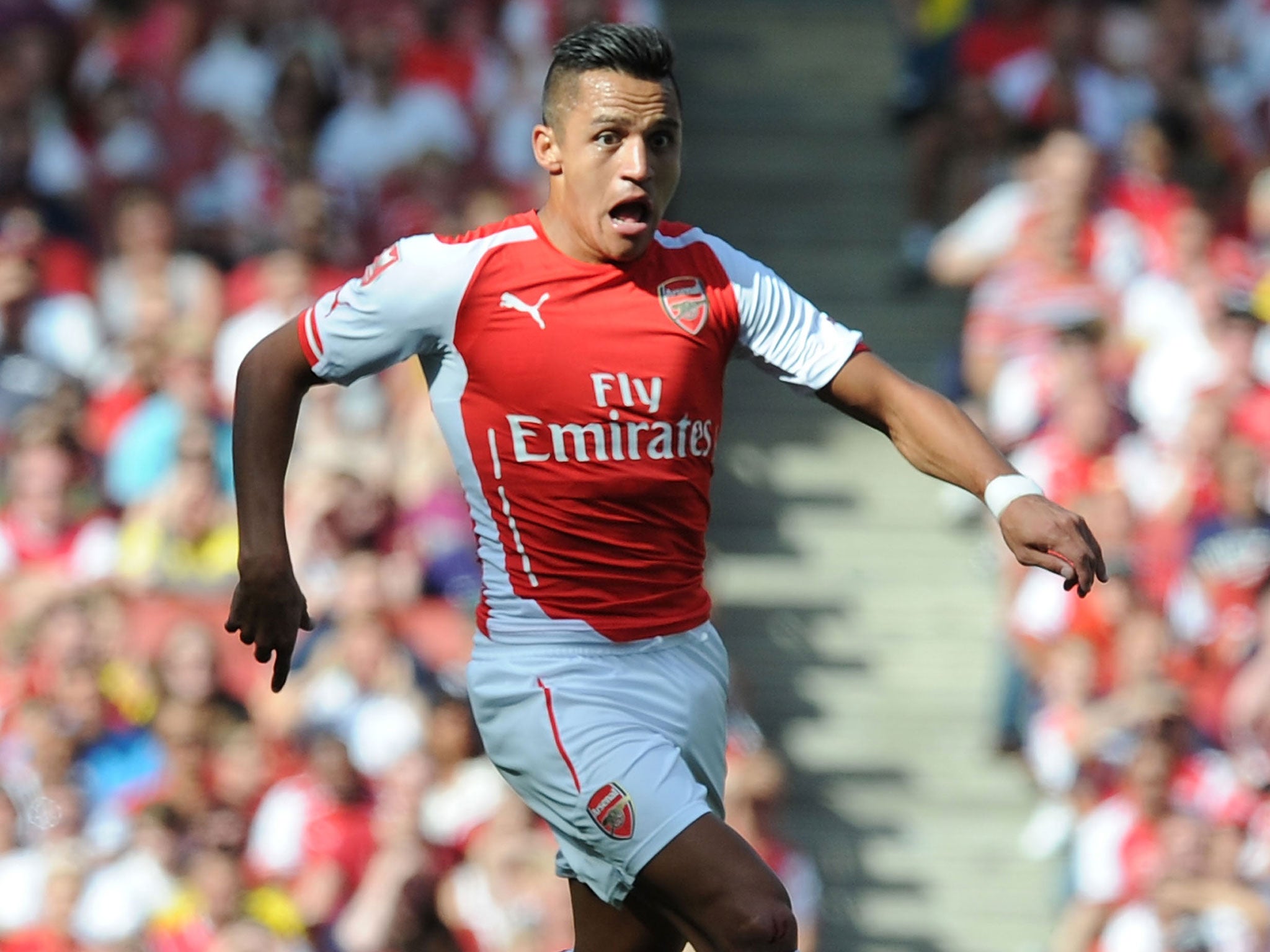 Alexis Sanchez runs with the ball against Monaco