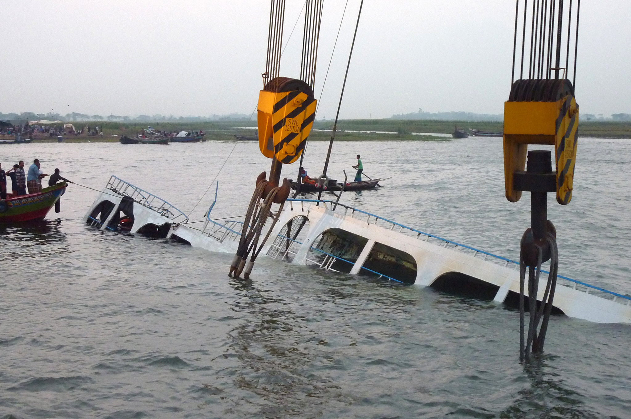 Bangladeshi rescue workers search for dead bodies inside the sunken ferry on the river Meghna in Munshiganj district, some 50 kilometres south of Dhaka. A heavily-laden ferry capsized and sank in central Bangladesh after being caught in a storm, leaving a