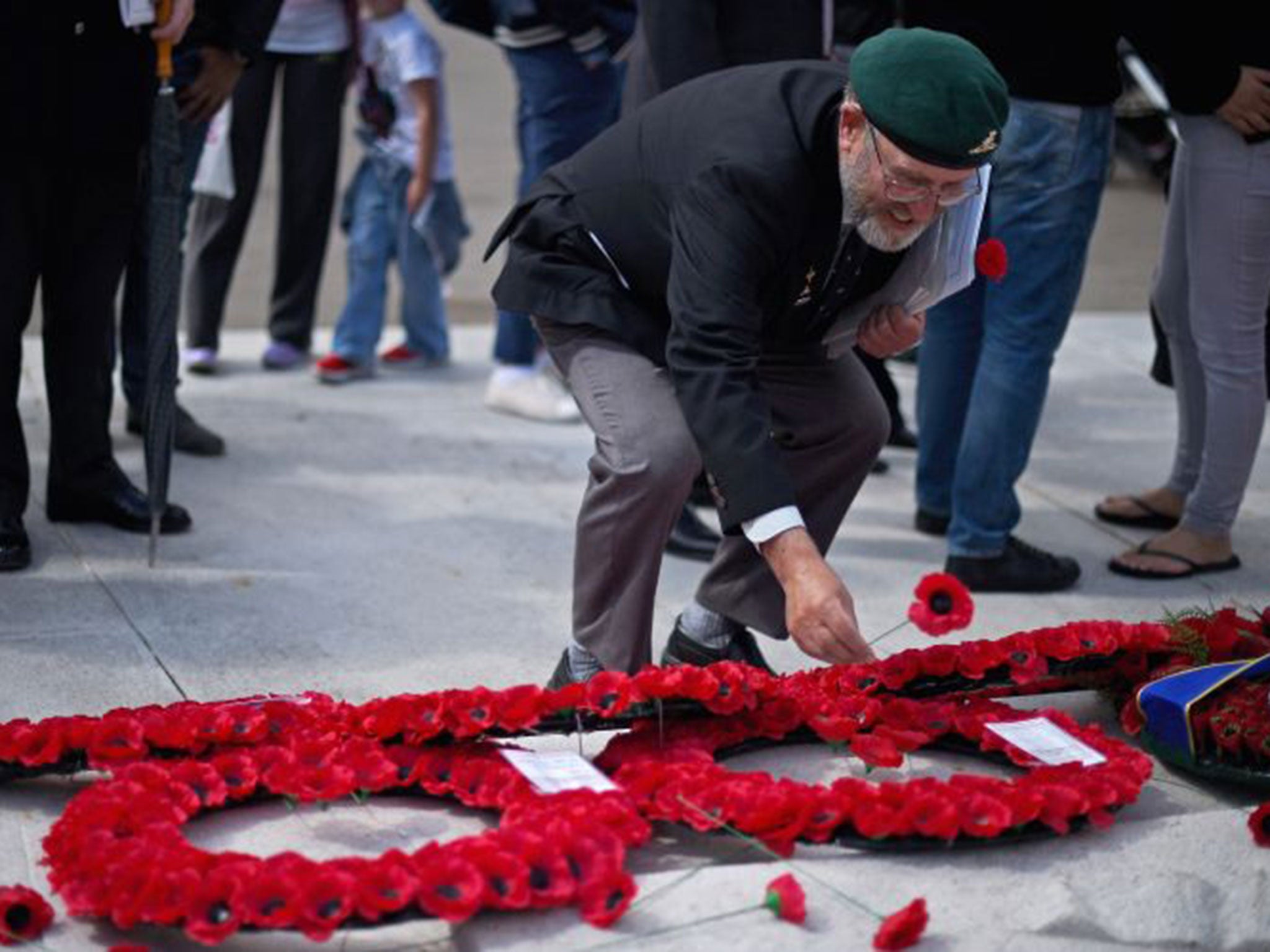 A former serviceman places a poppy to mark the centenary