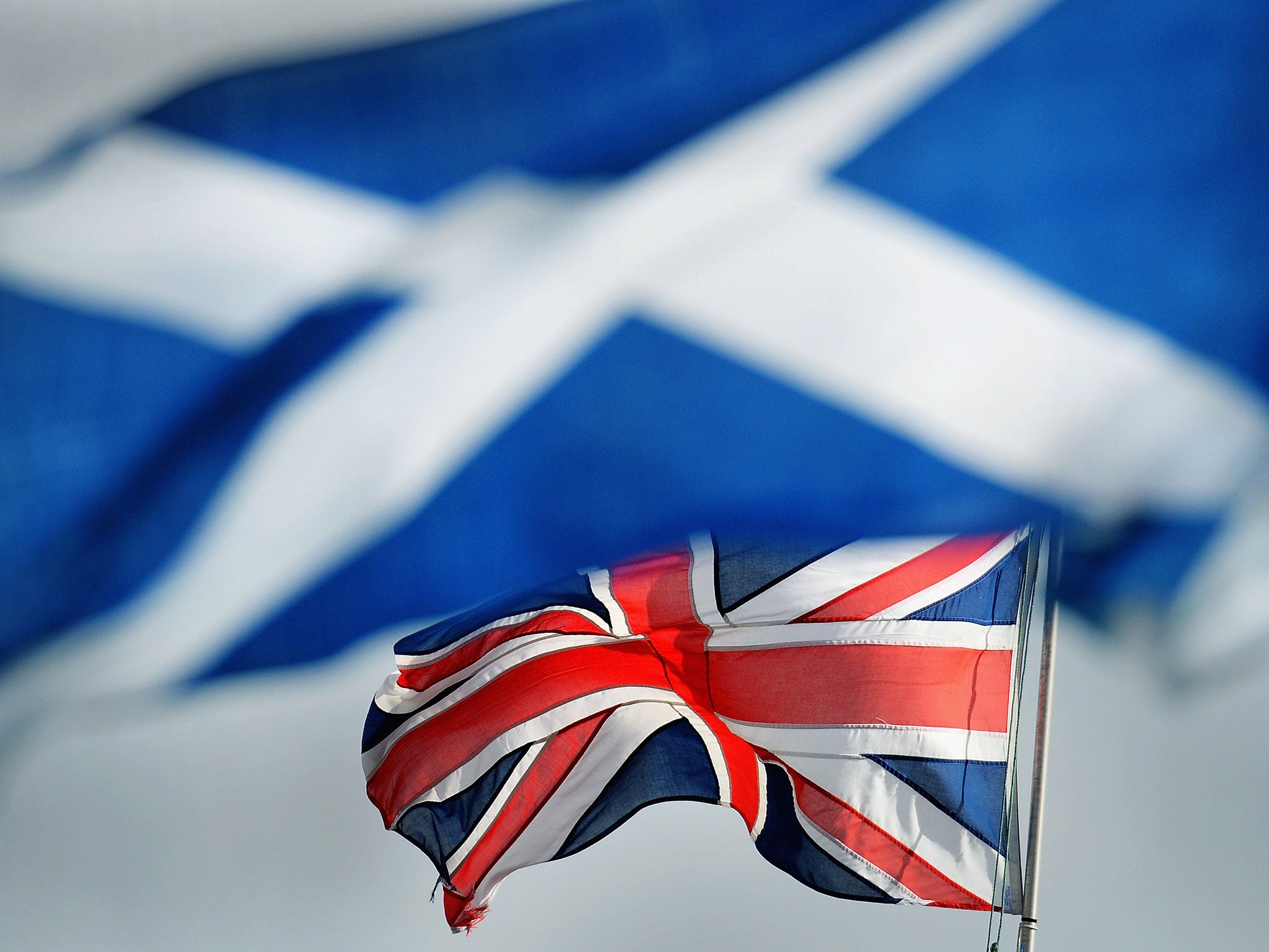 The Union and Saltire flags blow in the wind at the Cowal Highland Gathering