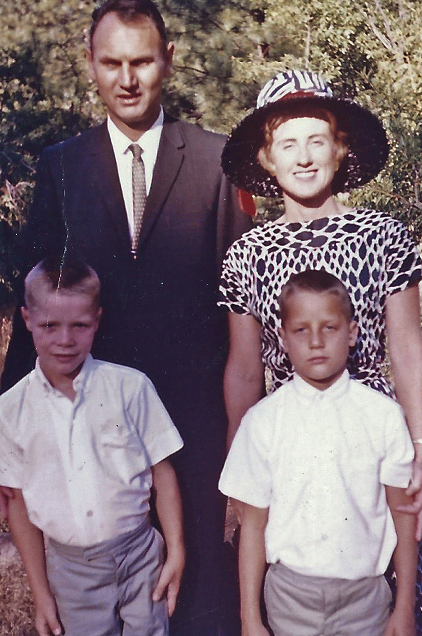 In this early 1960s photo provided by their granddaughter Melissa Sloan, Don Simpson and his wife, Maxine, pose with their children James Mack, left, and William Walter, whom they adopted in Germany.