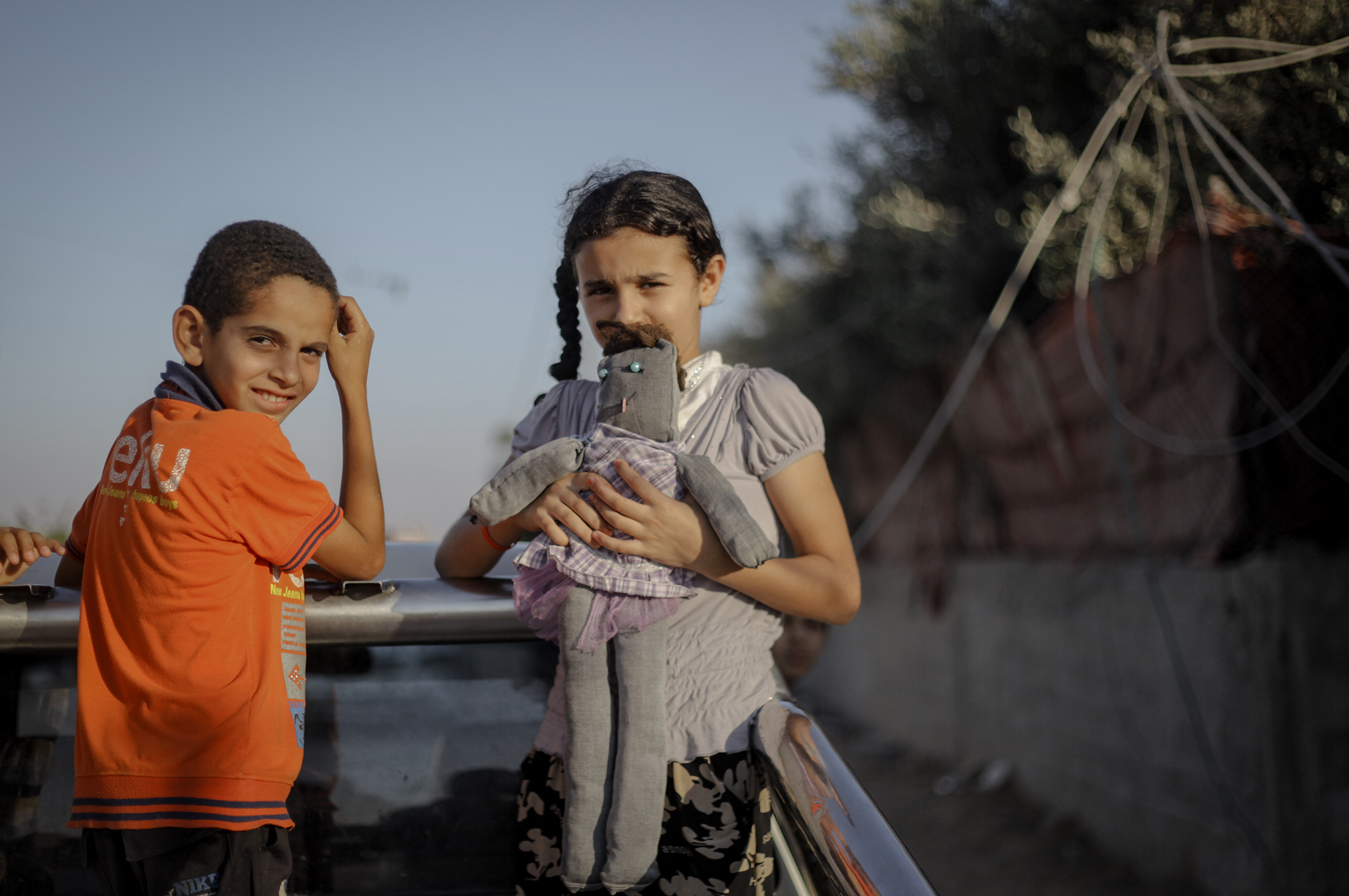 A Palestinian girl carries a toy she retrieved from their home, after the ground invasion of the Israeli army to the city of Rafah, during the granted 72 hours humanitarian truce mediated by Egyptian between the Palestinian and Israeli sides to stop the w