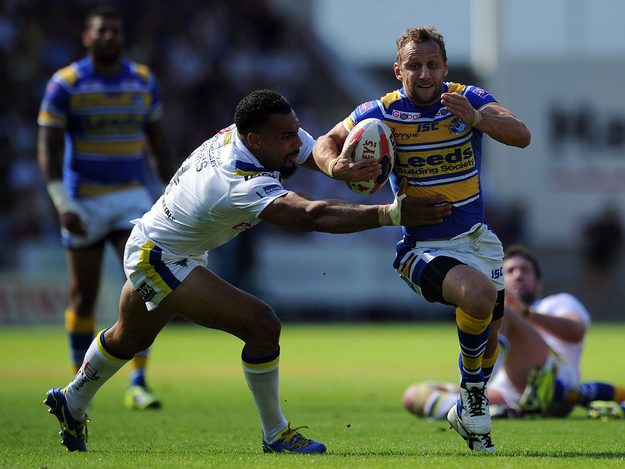 Rob Burrow evades the clutches of Warrington centre Ryan Atkins during Leeds' 24-16 victory