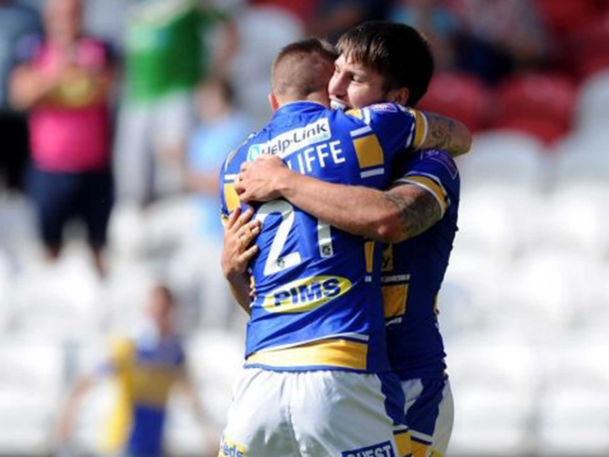 Amber nectar: Liam Sutcliffe congratulates Tom Briscoe for his Leeds try