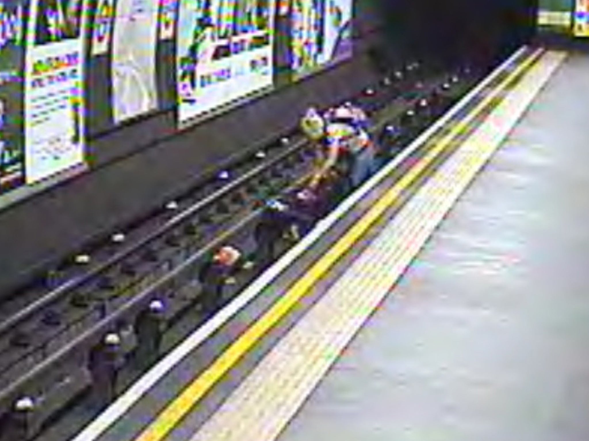 The buggy and the child's mother on the tracks - in the short gap between one train leaving and another arriving