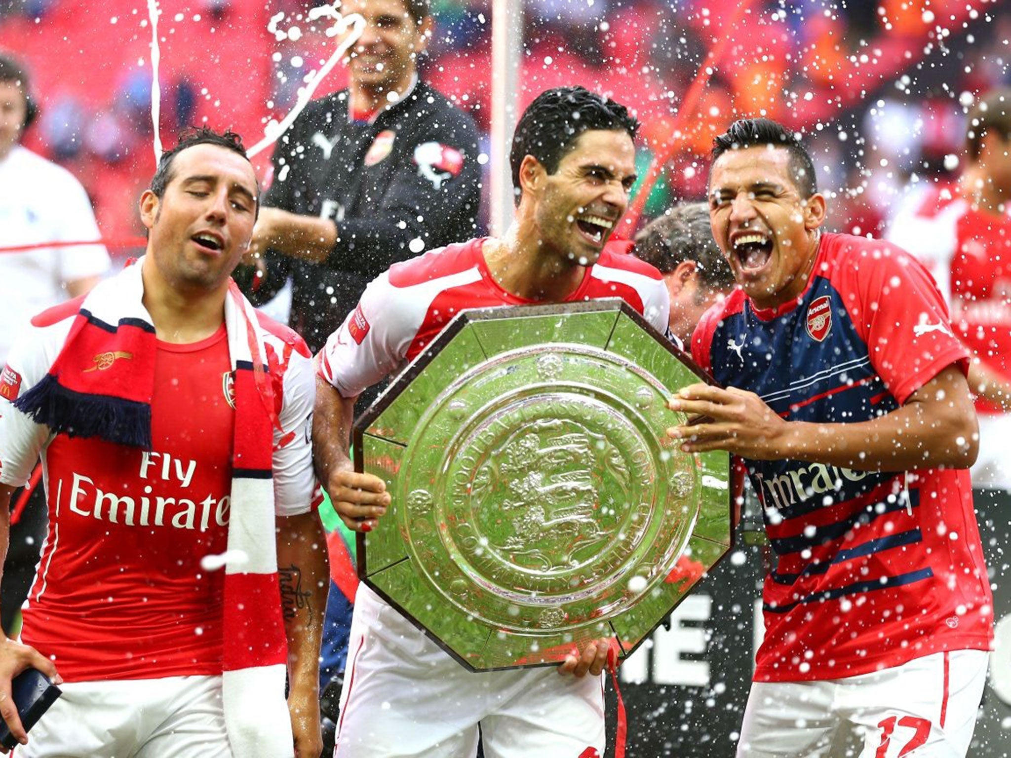 Santi Cazorla, Arteta and Alexis Sanchez celebrate with the Community Shield