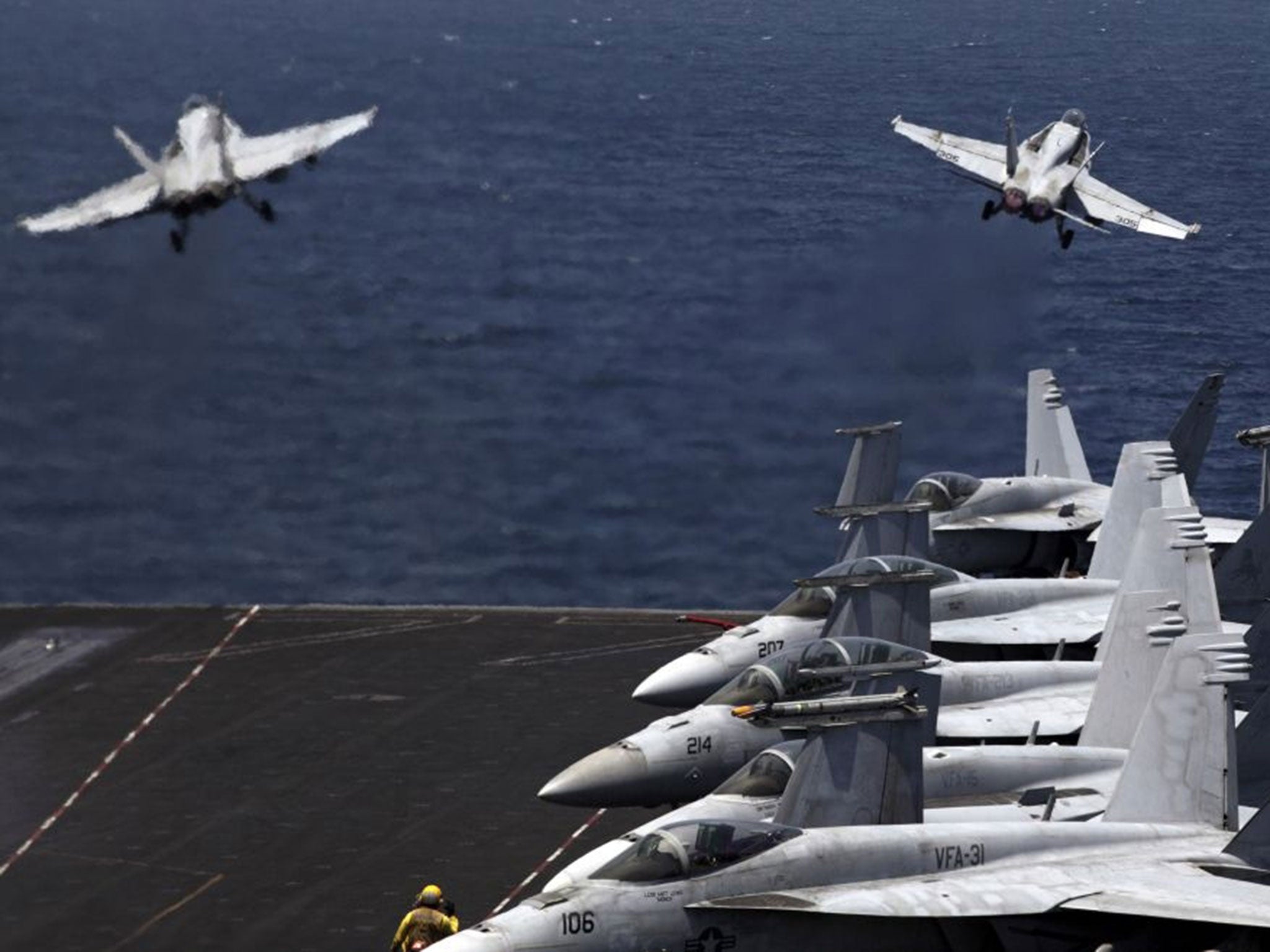 U.S. F/A-18 fighter jets take off for mission in Iraq from the flight deck of the U.S. Navy aircraft carrier USS George H.W. Bush, in the Persian Gulf, Monday, Aug. 11, 2014.