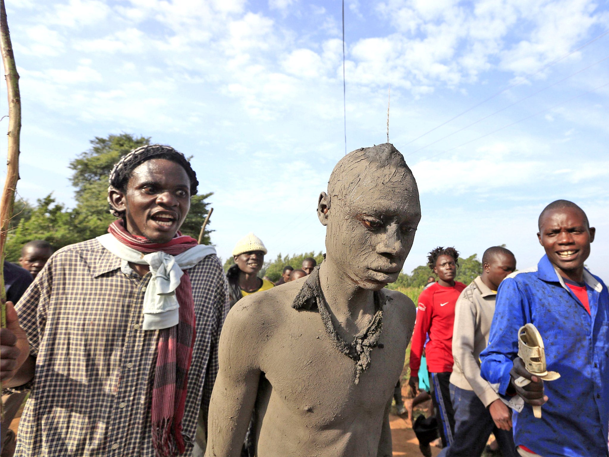 Bukusu villagers escort a teenager to the circumcision ritual in the Bungoma region in western Kenya