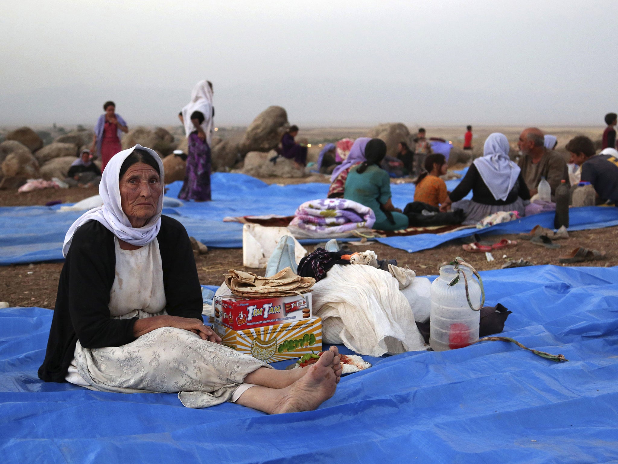 Displaced Iraqis from the Yazidi community settle at a camp at Derike, Syria. In the camps here, Iraqi refugees have new heroes: Syrian Kurdish fighters who battled militants to carve an escape route to tens of thousands trapped on a mountaintop