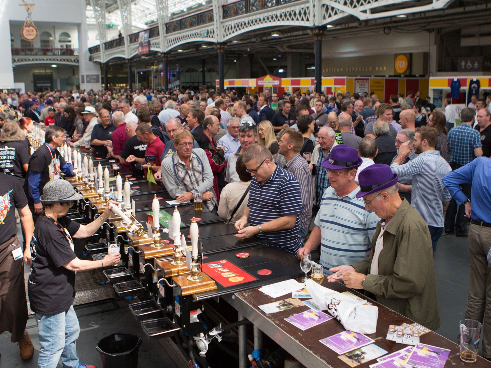 Attendees enjoy and taste different types of beer across Britain at the Great British Beer Festival (GBBF) in Olympia London, Keningston