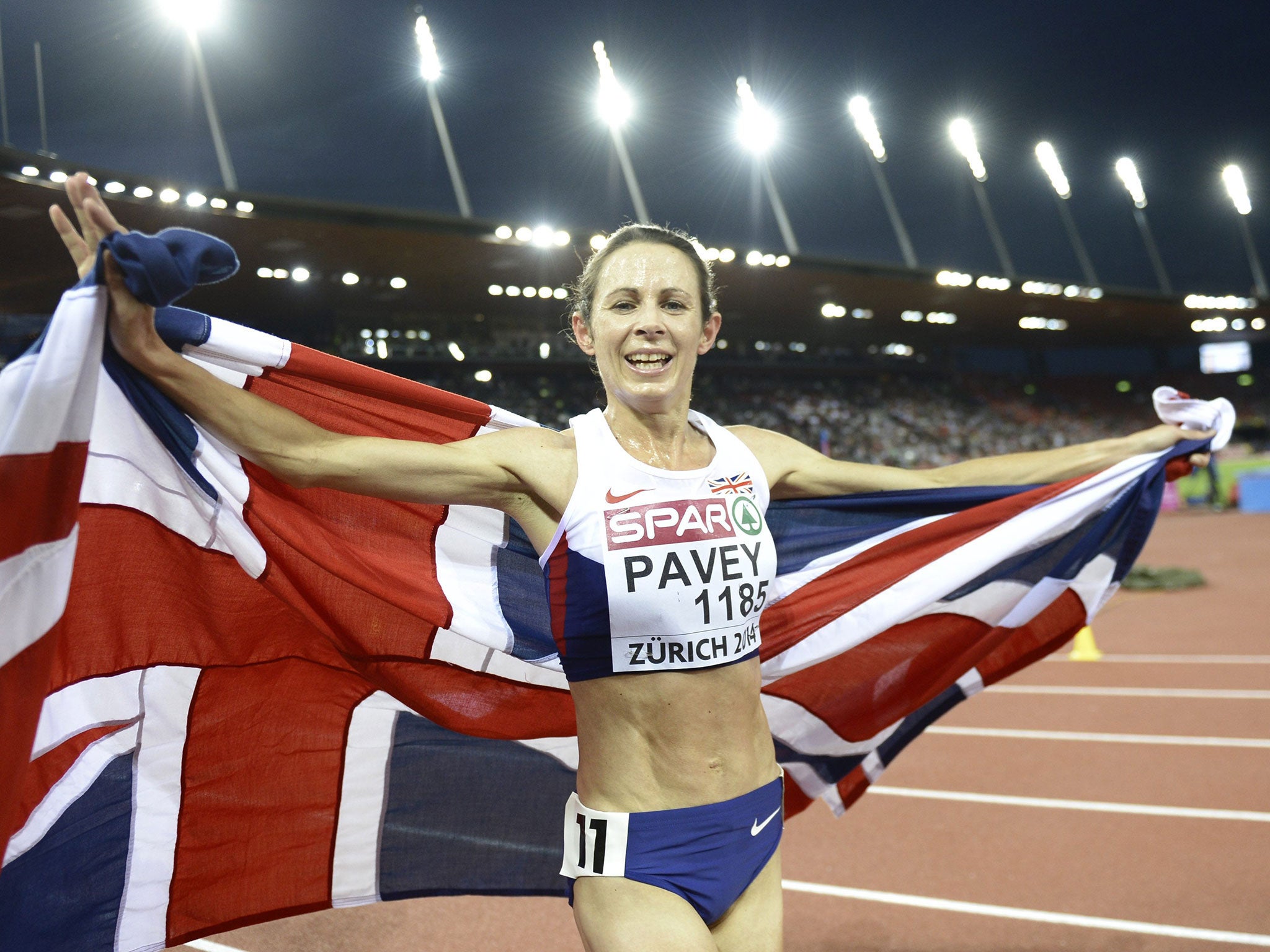 Jo Pavey from Great Britain poses with the flag after the women's 10'000m final race