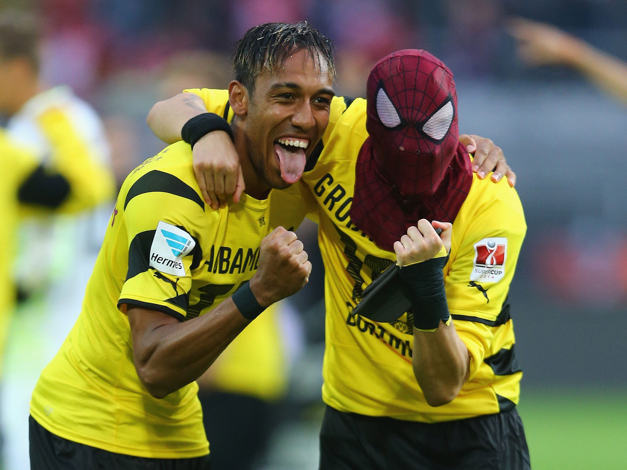 Pierre-Emerick Aubameyang lets Kevin Grosskreutz wear his Spider Man mask after the full-time whistle