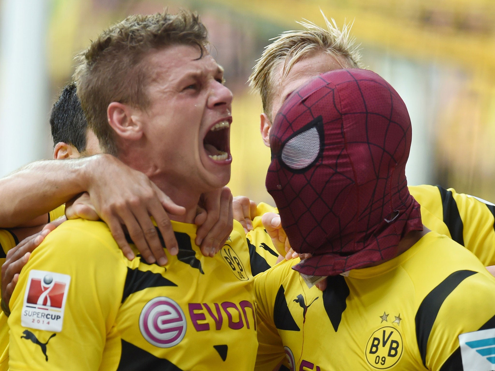 Lukasz Piszczek celebrates after Aubameyang, wearing a Spiderman mask, scores