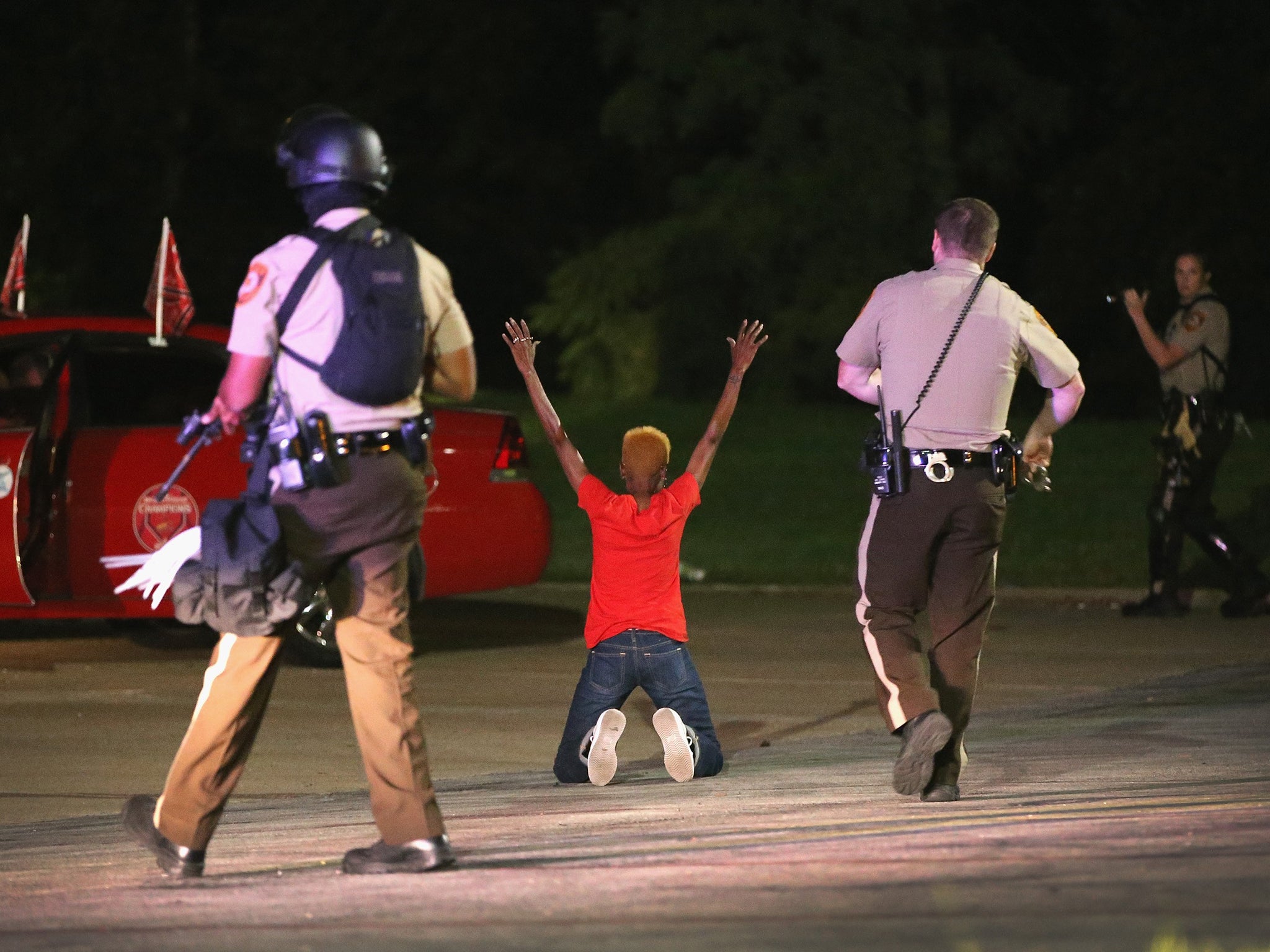 Police surround and detain two people in a car in Ferguson