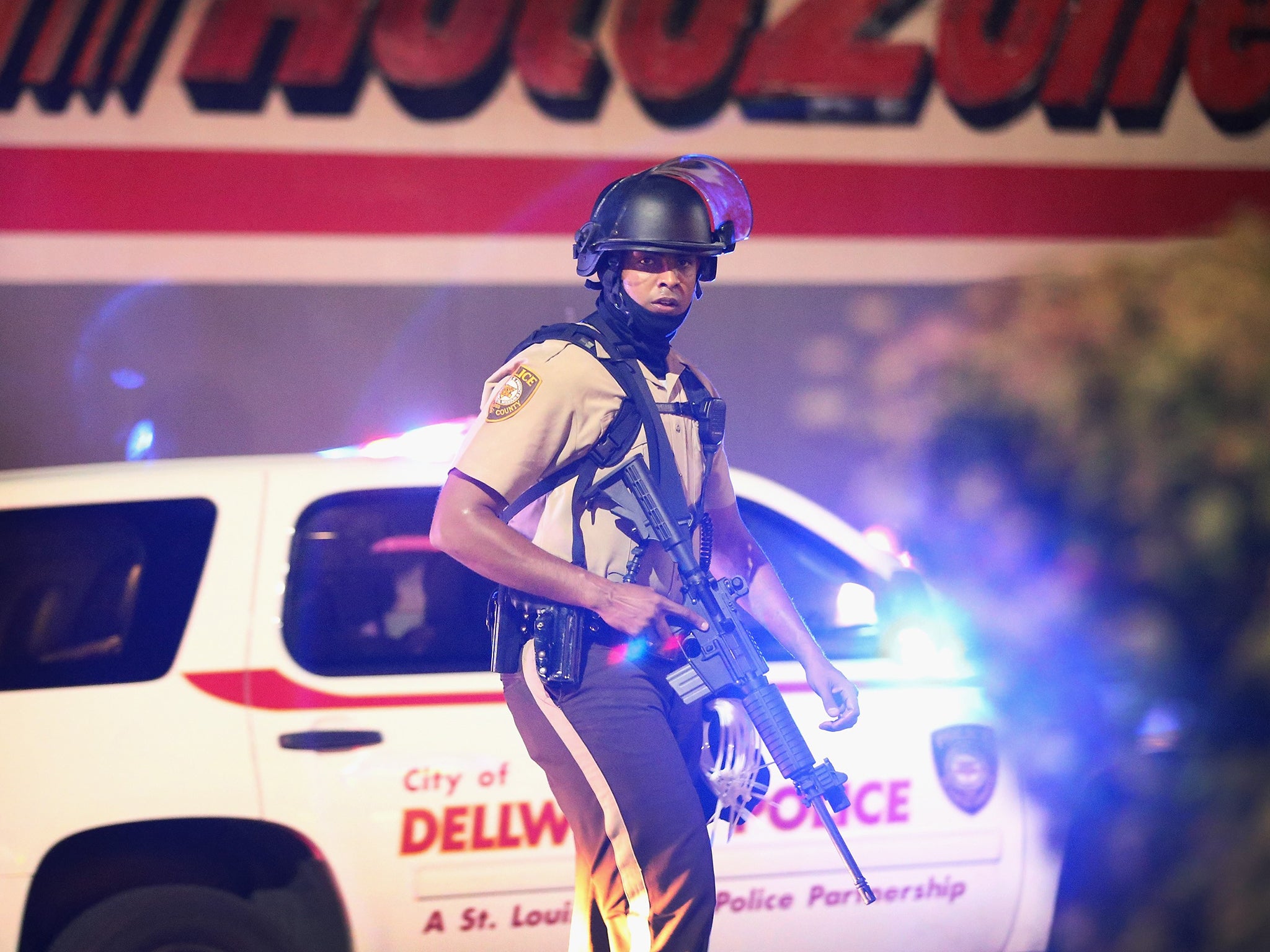 A police officer patrols a business district in Ferguson