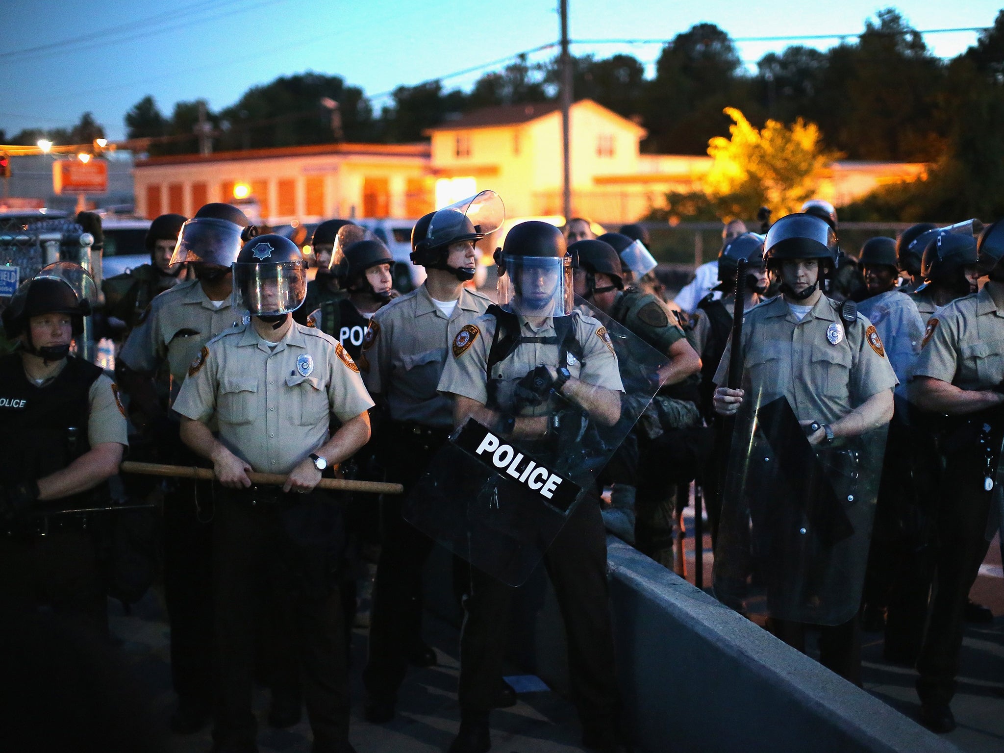 Police stand watch during the demonstrations. These are not thought to be the officers referred to in the report below